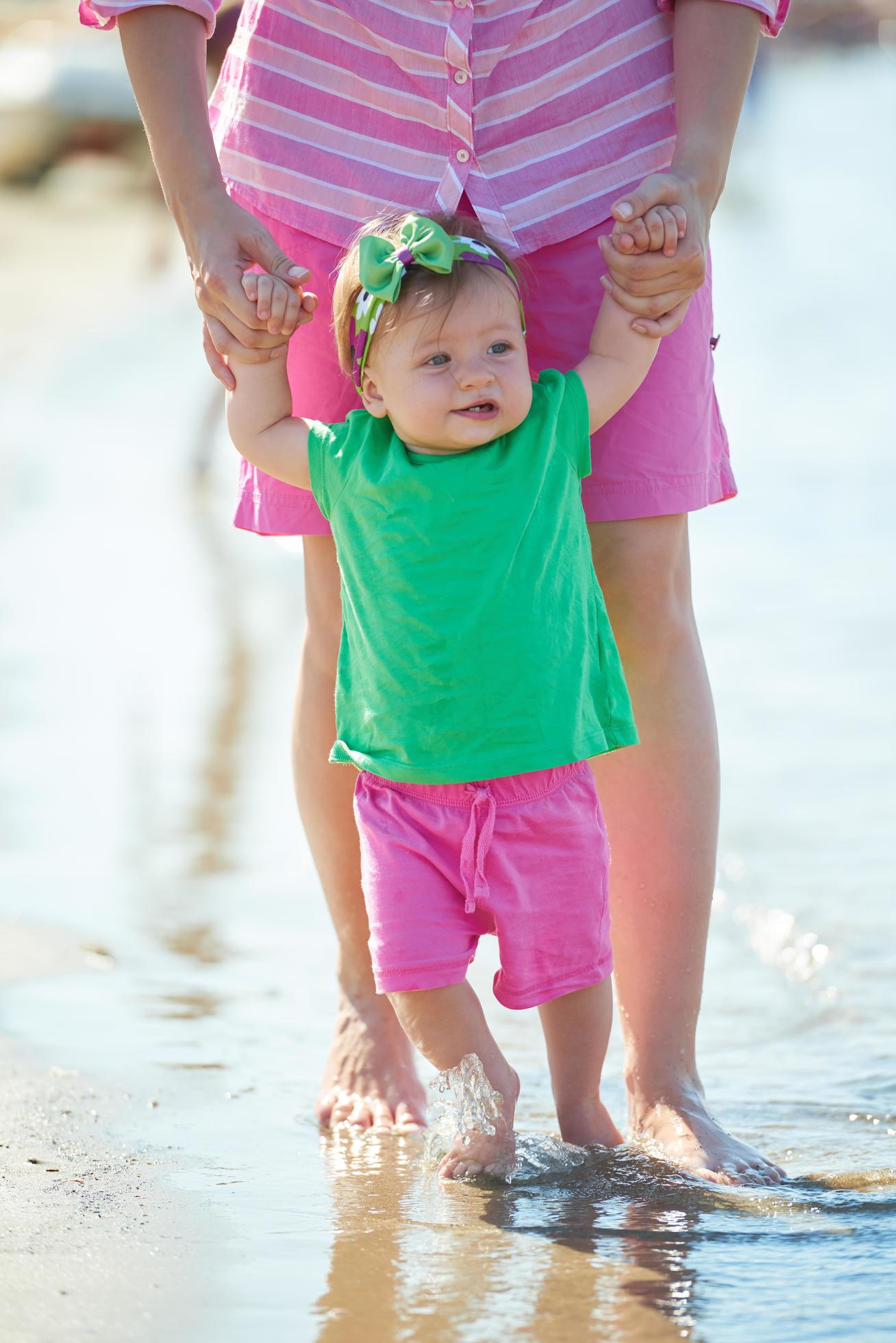 mom and baby on beach have fun Stock Free