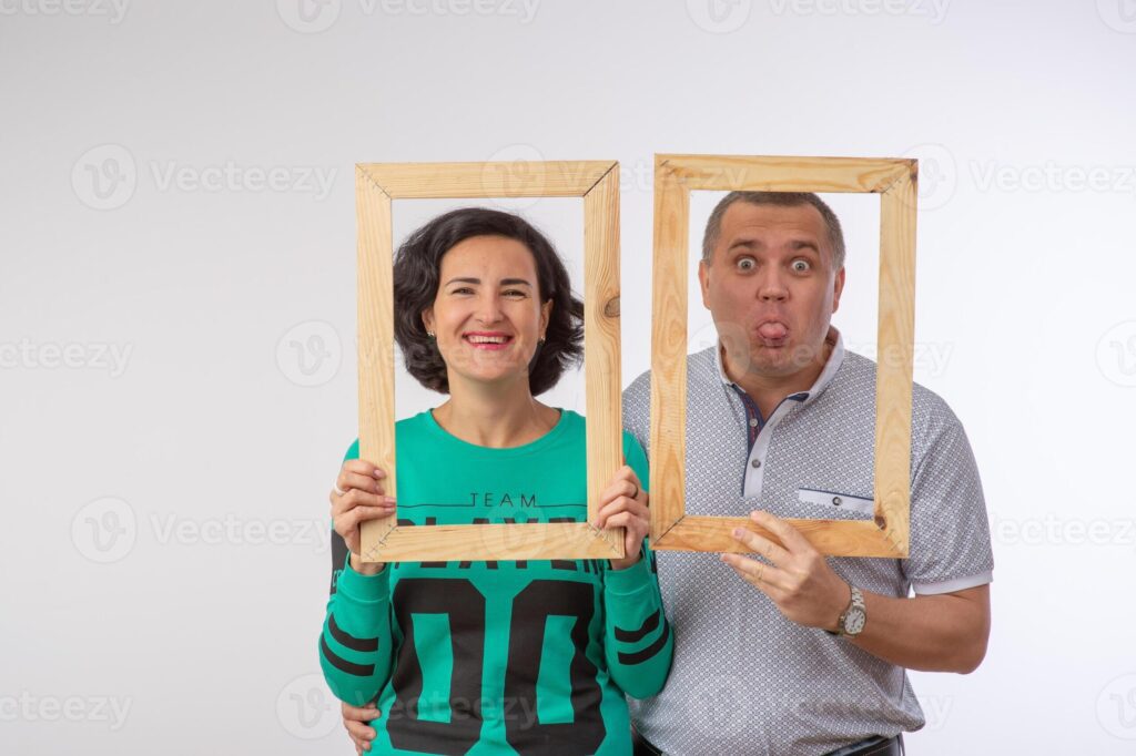 studio portrait of husband and wife in photo frame happy family 1 Pro Photo