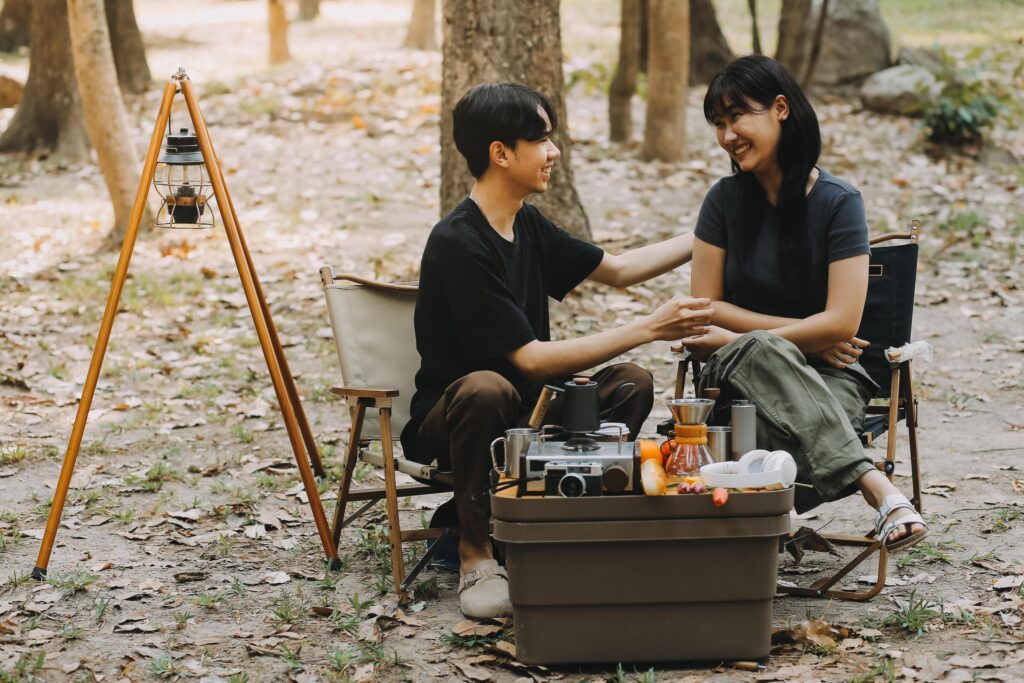 Asian couple sweet in tent inside on they camping trip, traveller relax and sleep togather in out door and camping trip Stock Free