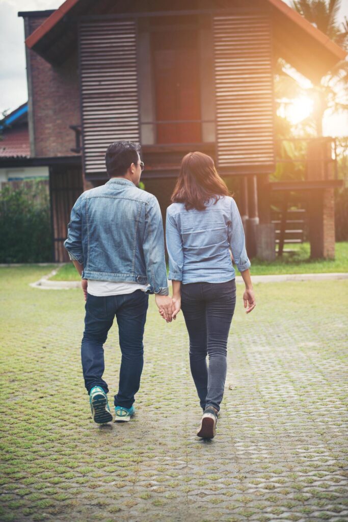 Close-up of loving couple holding hands while walking outdoor, Couple in love concept. Stock Free