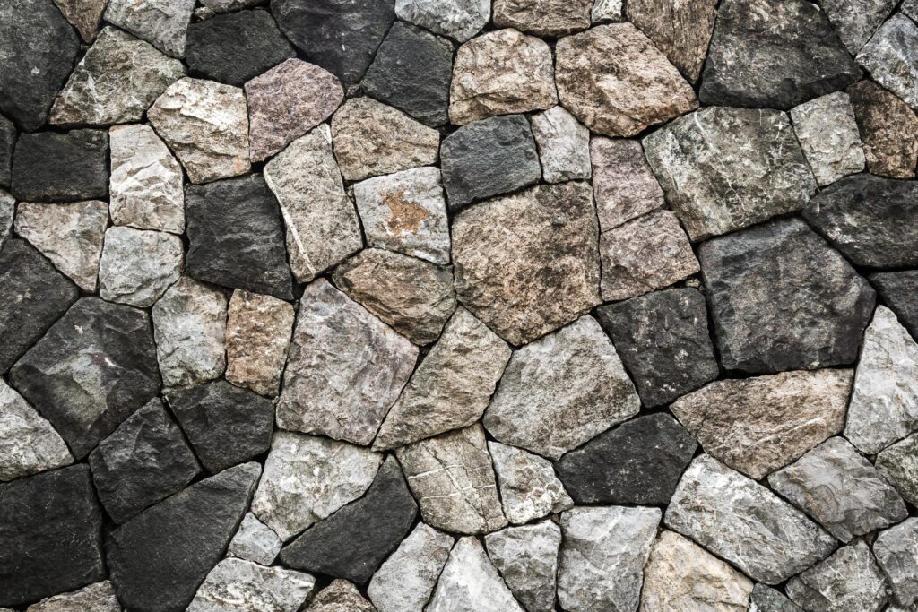 Stone wall background and texture with space Stock Free