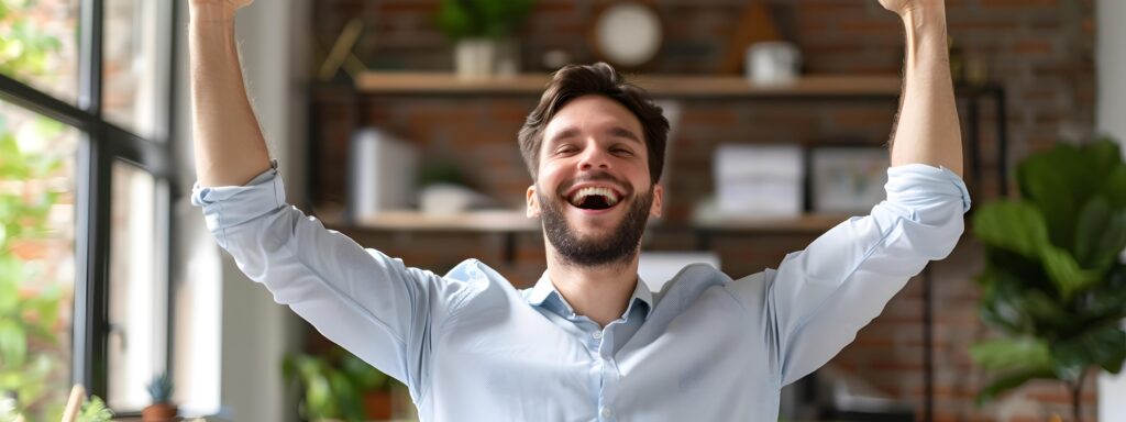 Excited Young Business Executive Celebrating Success in Office Workspace Stock Free