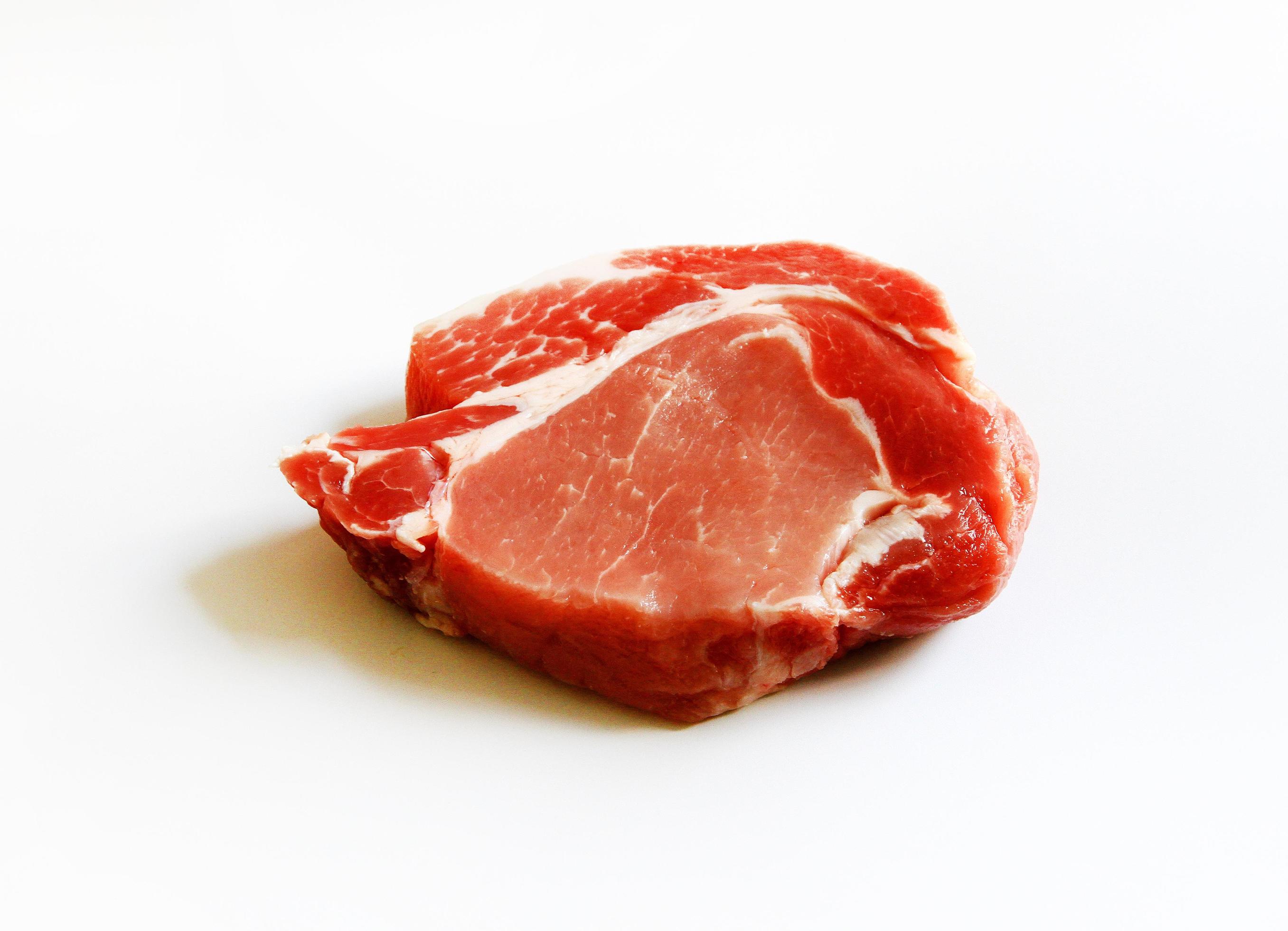 Close up fresh sliced pork, meat or beef isolated on white background. Uncooked food. Freshness piece of steak prepare for grill or fried. Stock Free