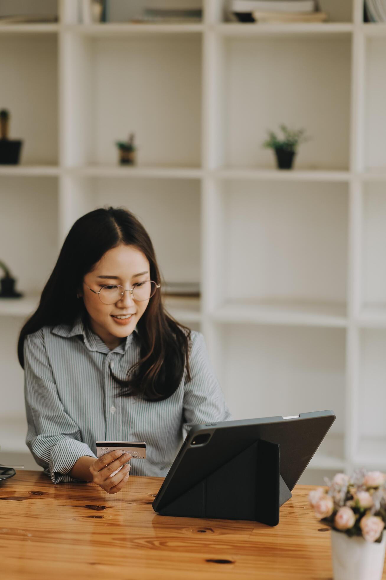 Happy asian woman using smartphone shopping online with credit card. Lifestyle. Easy pay using smart phone or digital device. Stock Free