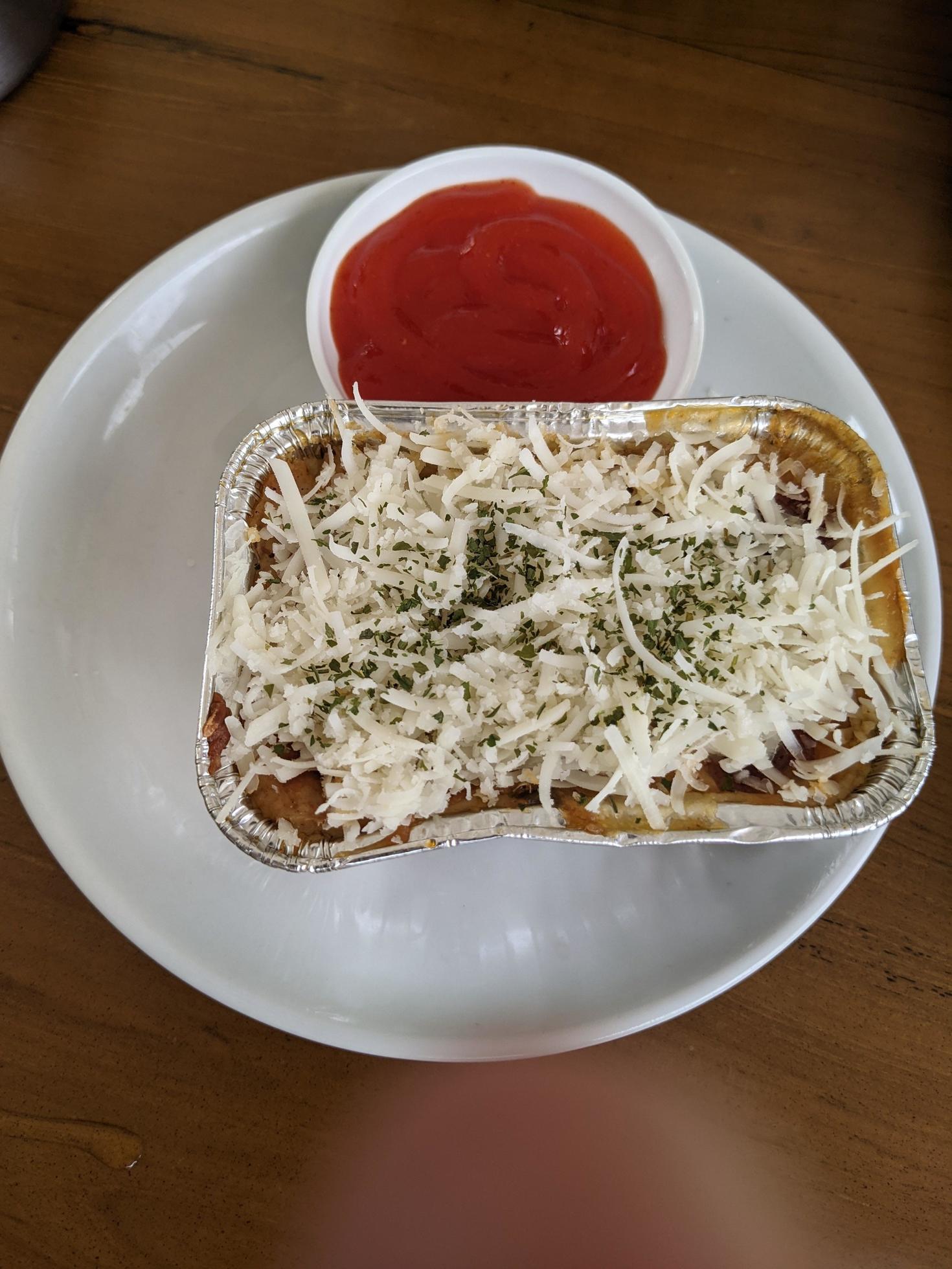 Cedar Cheese and mozzarella on the roasted beef lasagna with chili sauce. The photo is suitable to use for food background, poster and food content media. Stock Free