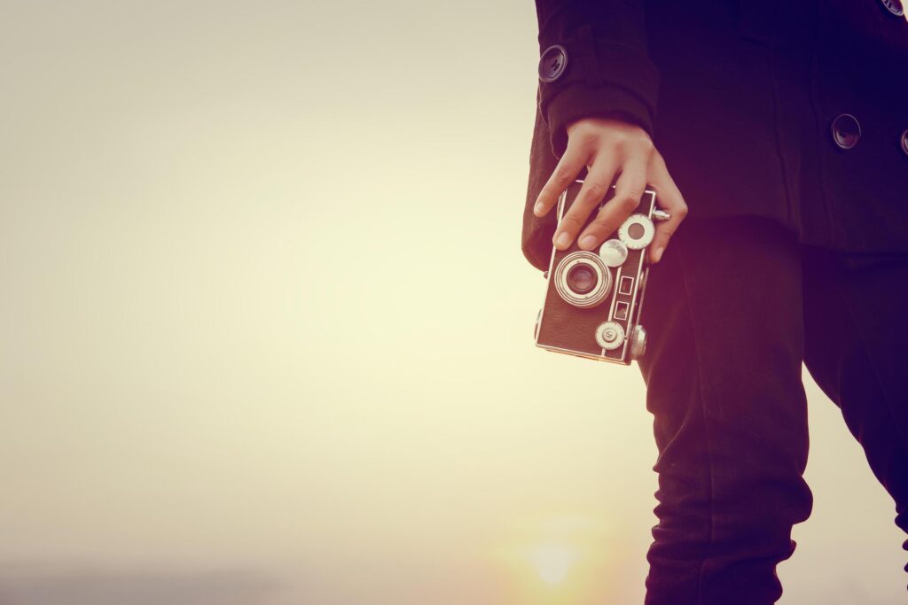 Young woman hands holding retro camera close-up Stock Free