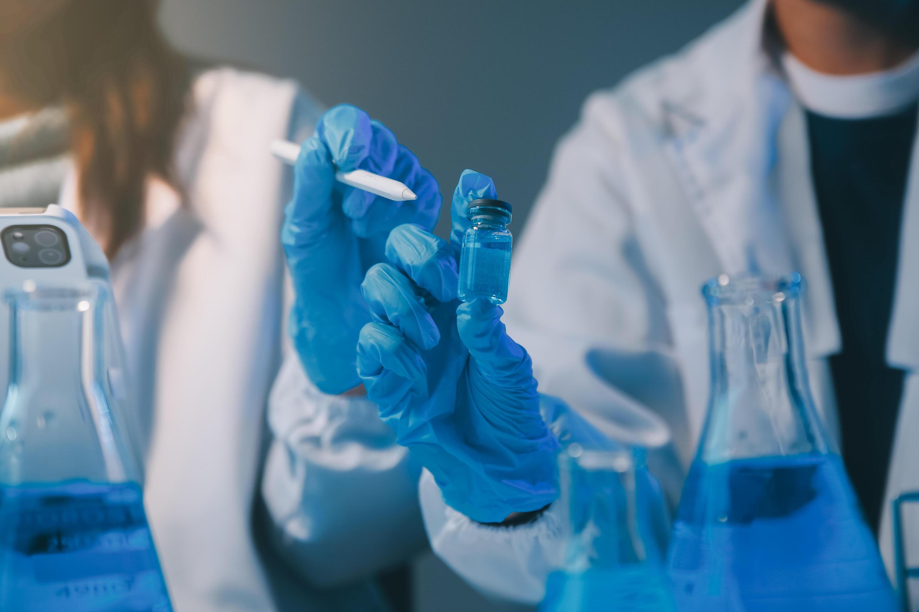 chemist,scientist hand dropping chemical liquid into test tube, science research and development concept Stock Free