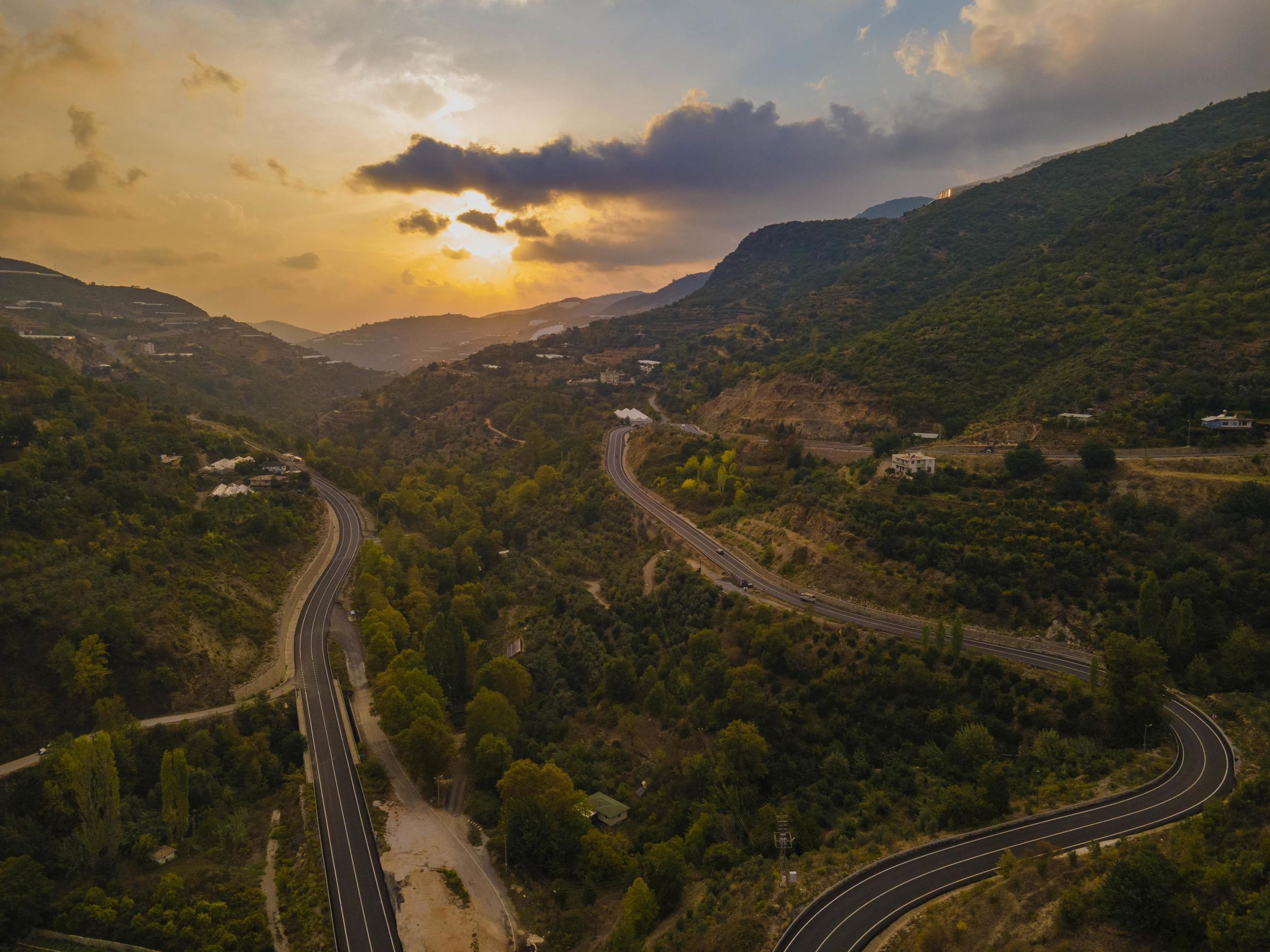 aerial valley and road, Top view, amazing nature background. sunset Flying drone, seascape Stock Free