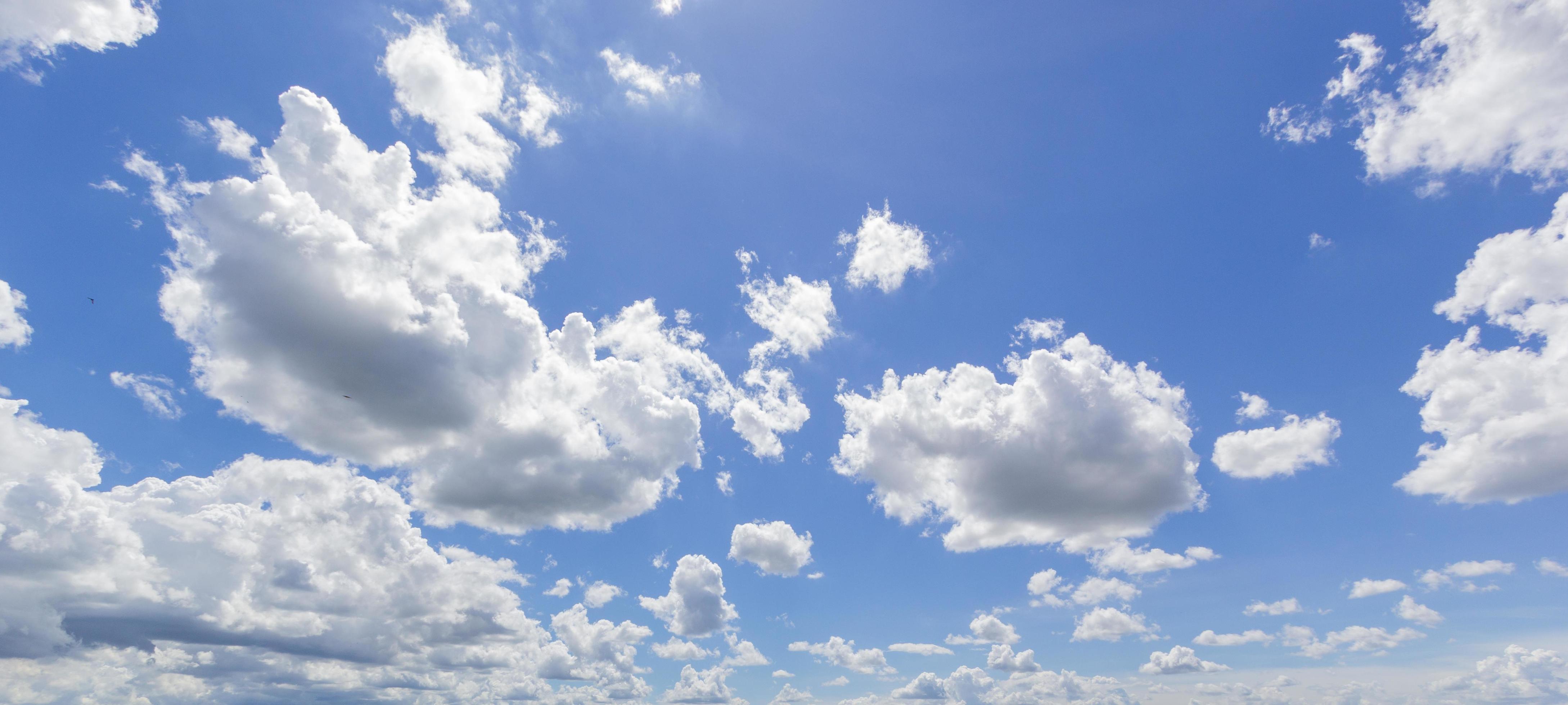 Natural abstract background of bright blue sky and fluffy white clouds on a sunny. Stock Free