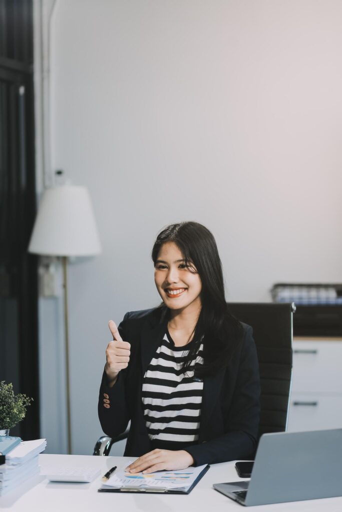 Young pretty business woman with notebook in the office Stock Free