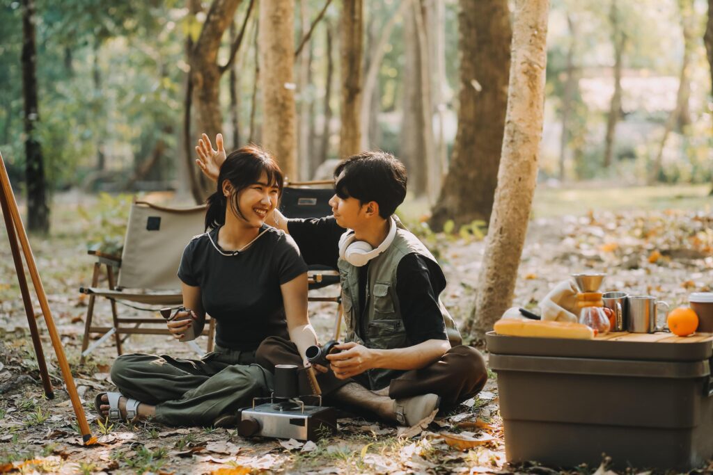 Asian couple sweet in tent inside on they camping trip, traveller relax and sleep togather in out door and camping trip Stock Free