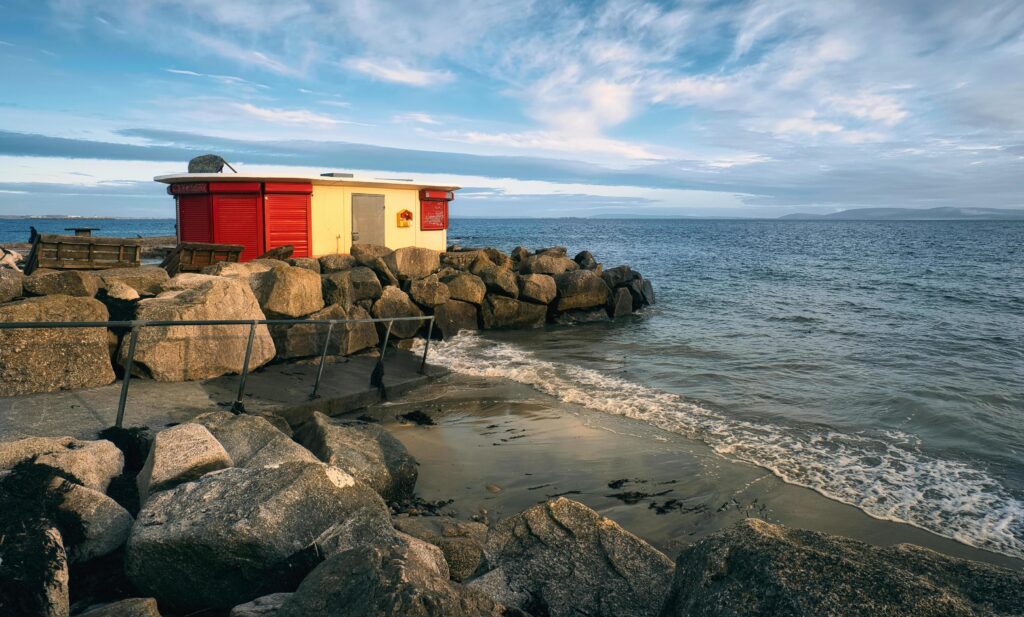 Beautiful coastal scenery with beach house on sandy Salthill beach in Galway, Ireland Stock Free