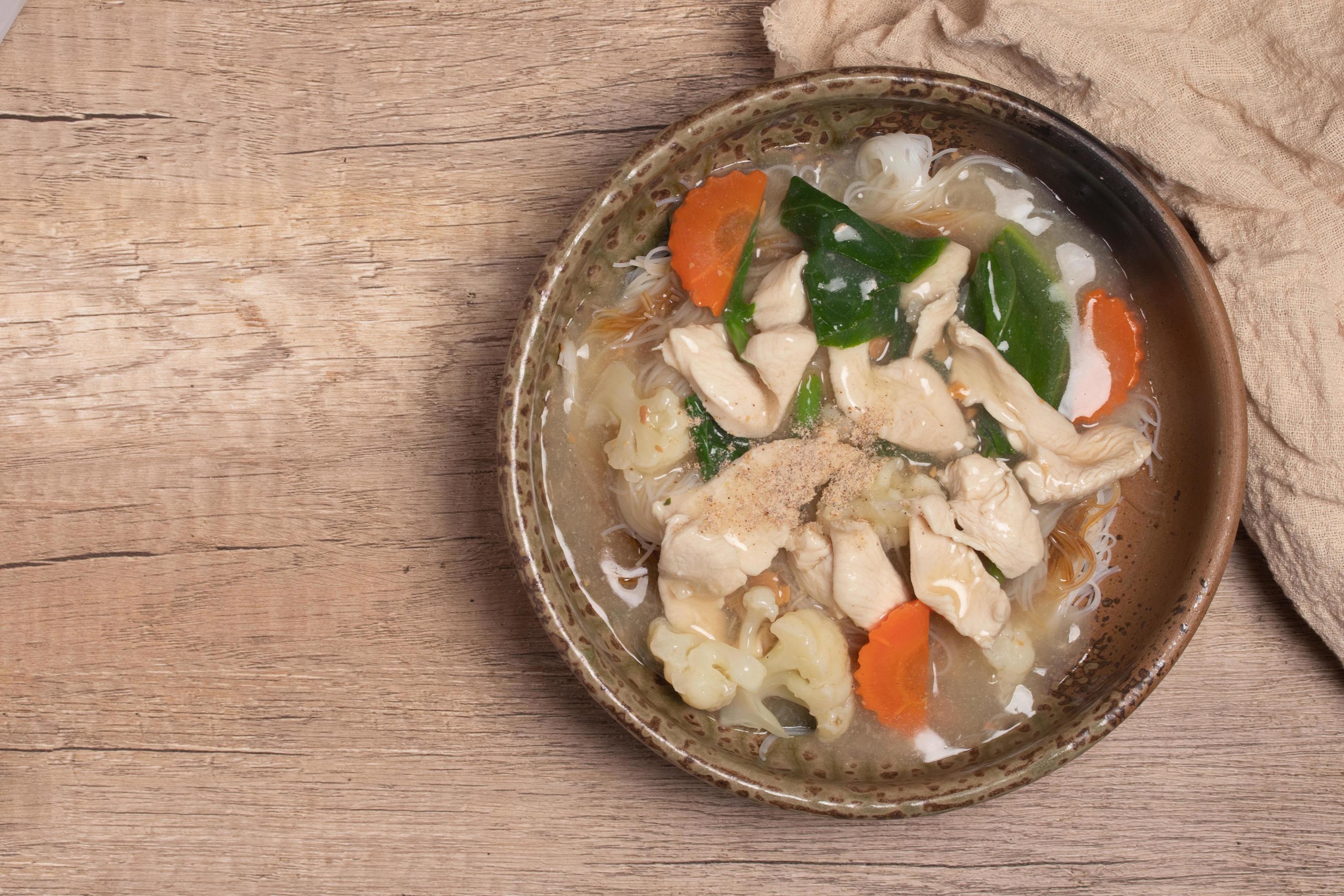 Thai Chicken and Gravy with vegetables poured over noodles.Thai food. Stock Free