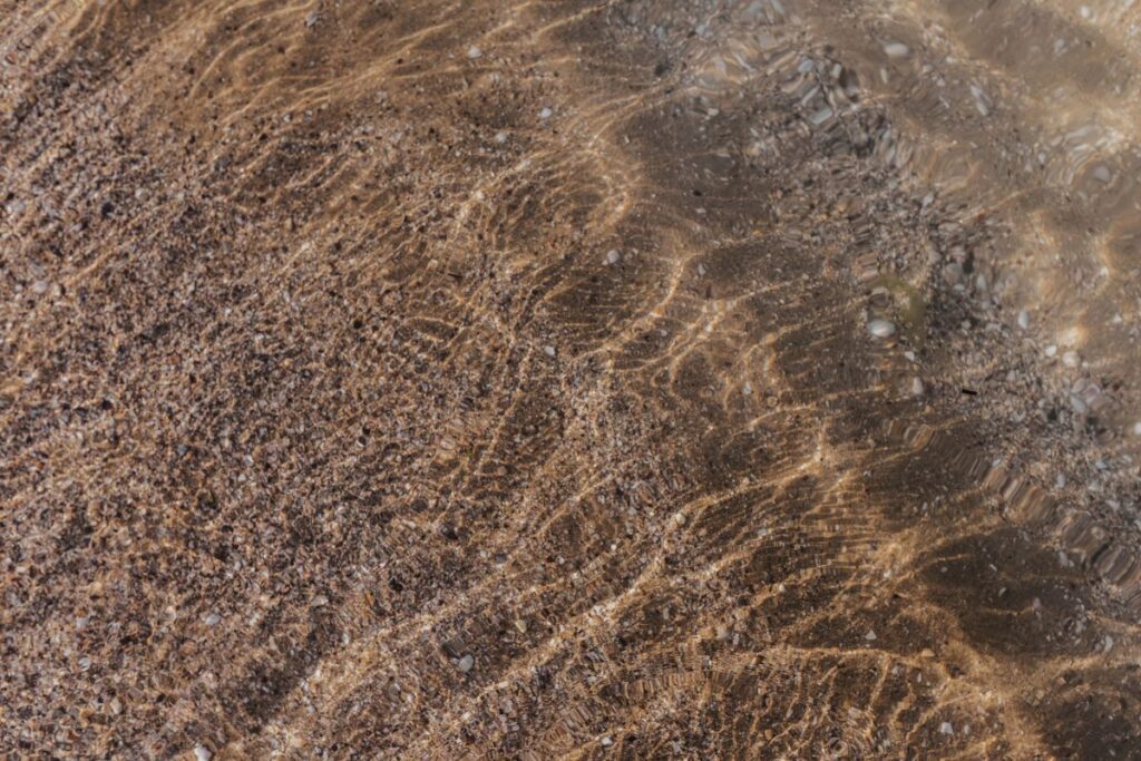 Soft wave of the sea on the sandy beach Stock Free