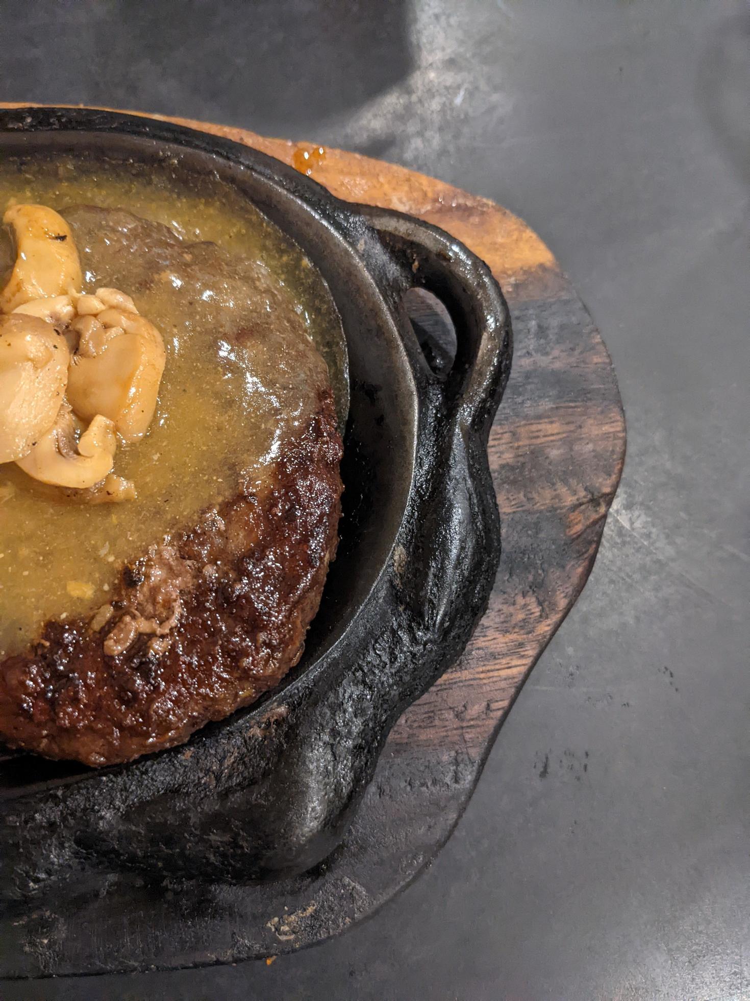 Extra beef steak with noodles and mushroom sauce. The photo is suitable to use for food background, poster and food content media. Stock Free