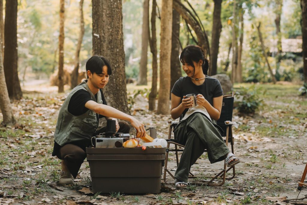 Asian couple sweet in tent inside on they camping trip, traveller relax and sleep togather in out door and camping trip Stock Free