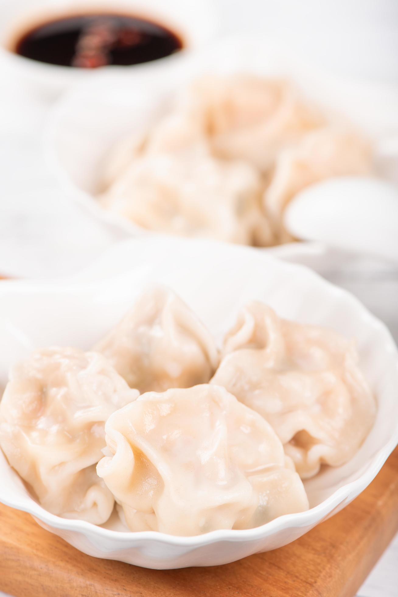 Fresh, delicious boiled pork gyoza dumplings, jiaozi on white background with soy sauce and chopsticks, close up, lifestyle. Homemade design concept. Stock Free