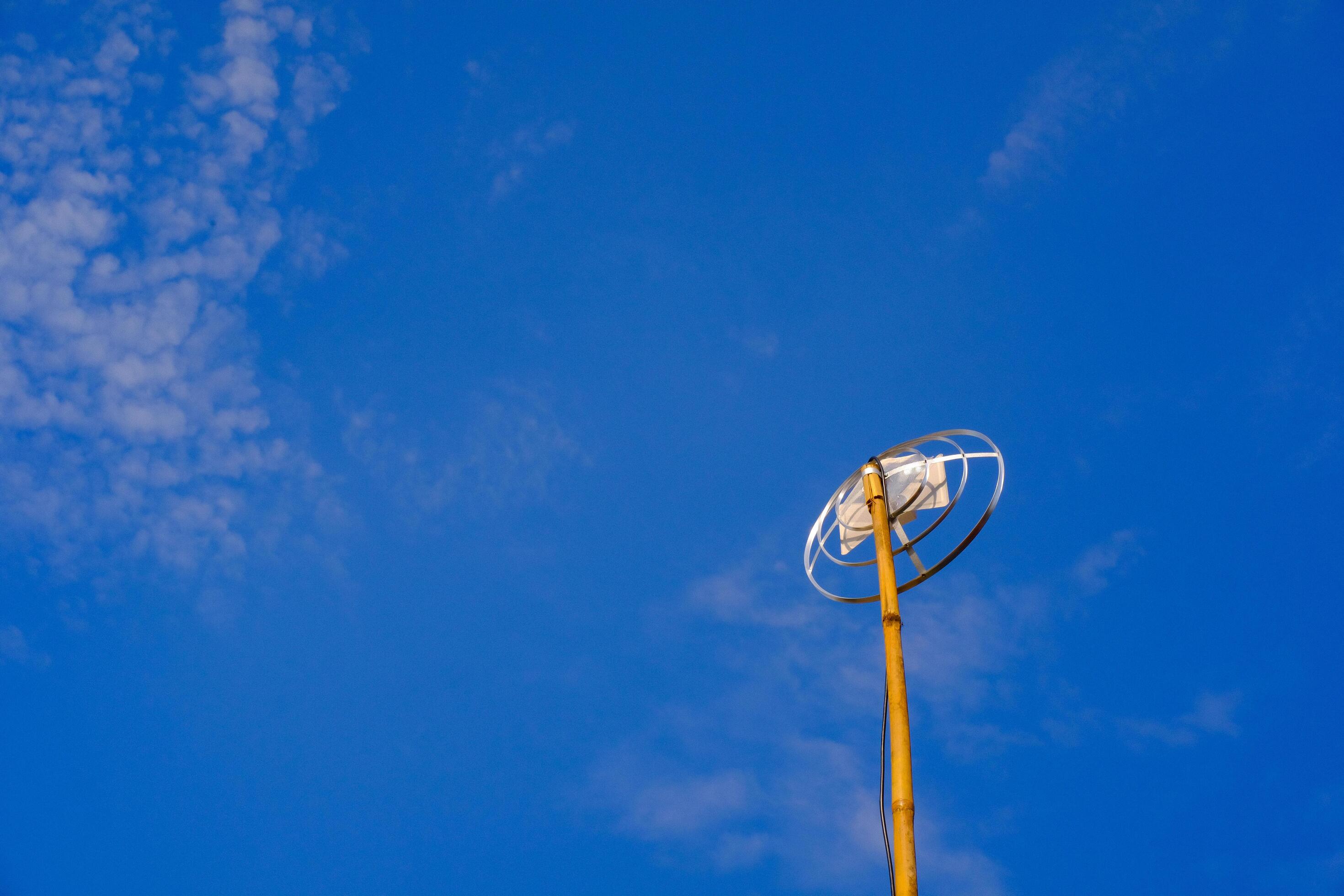 Landscape Photography. Landscape View. TV antenna with bamboo pole. A TV antenna with a blue sky background. Bandung, Indonesia Stock Free