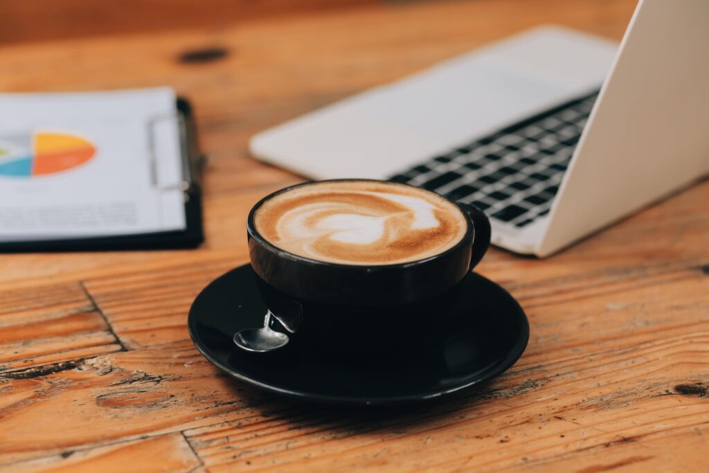 Closeup of coffee cup on table in empty corporate conference room before business meeting in office Stock Free