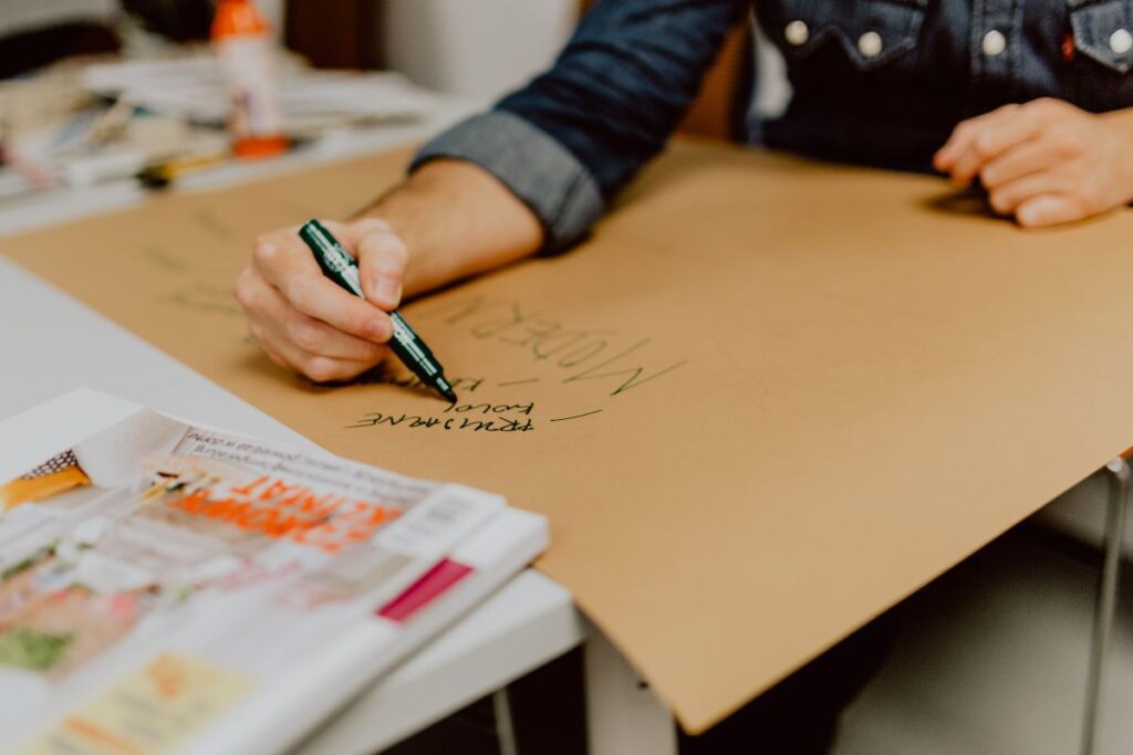 Man hand holding a green marker pen Stock Free