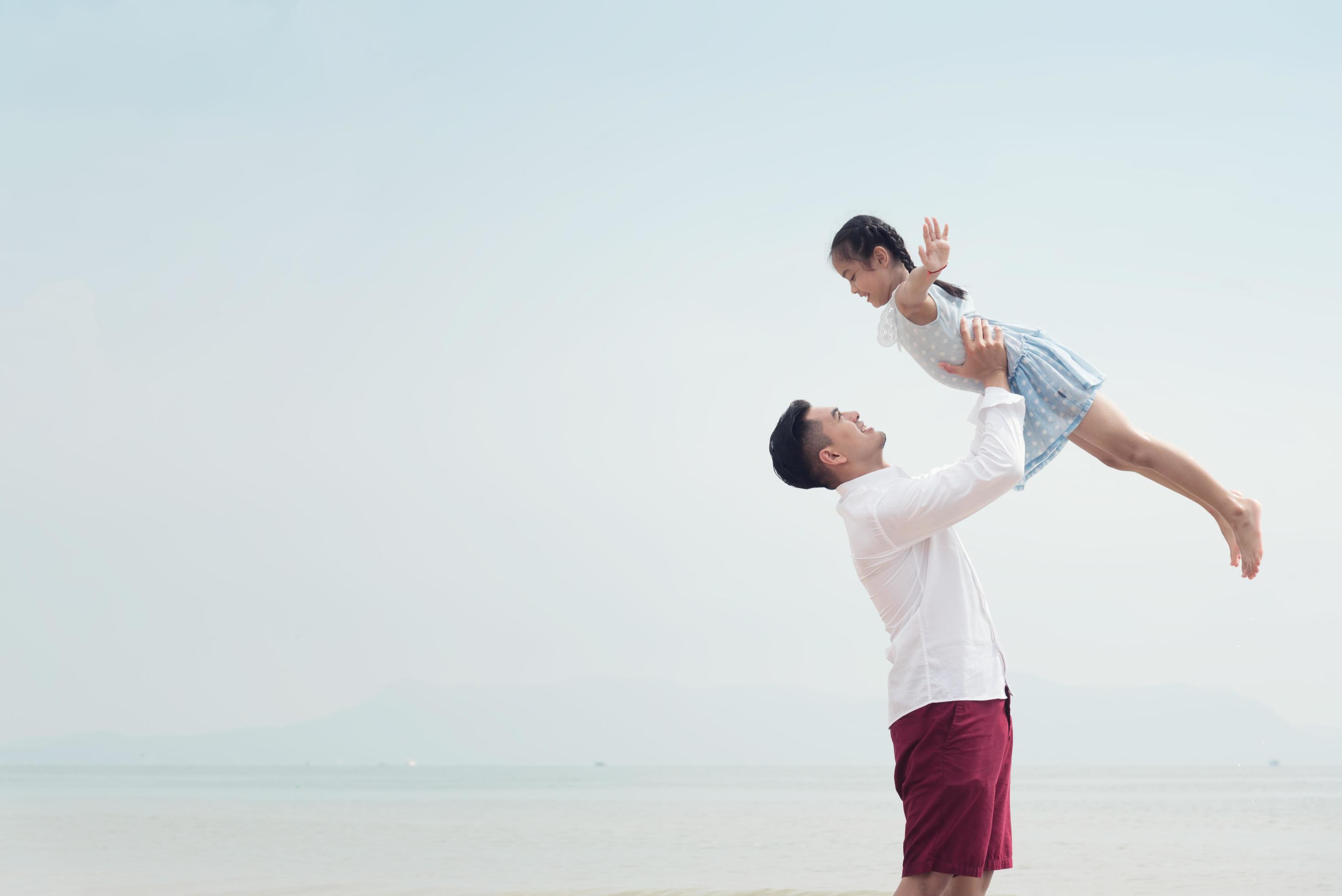 Happy family on beach run and jump at sunset Stock Free