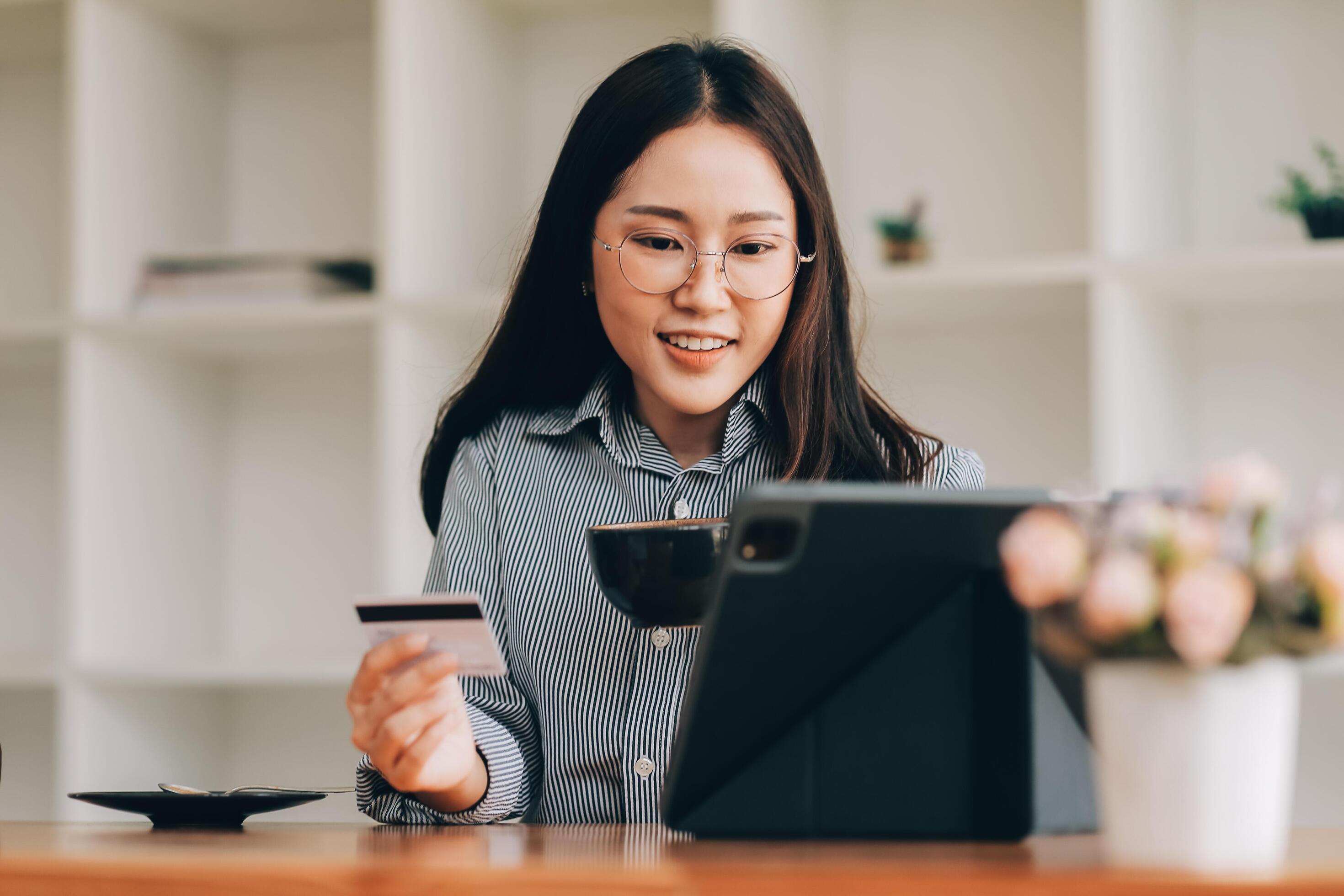 Happy asian woman using smartphone shopping online with credit card. Lifestyle. Easy pay using smart phone or digital device. Stock Free