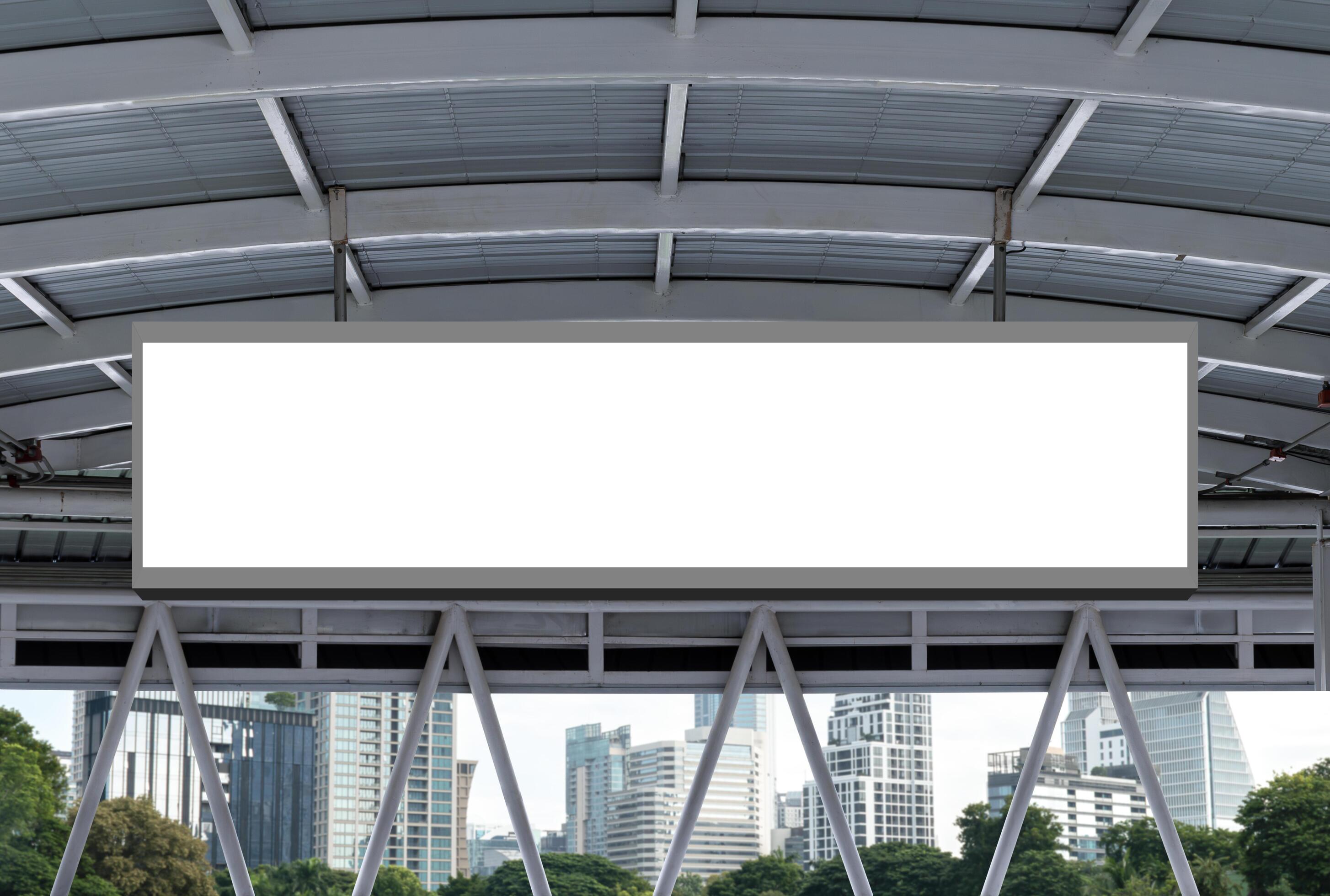 Mock up hanging white rectangle billboard at footbridge with cityscape background Stock Free