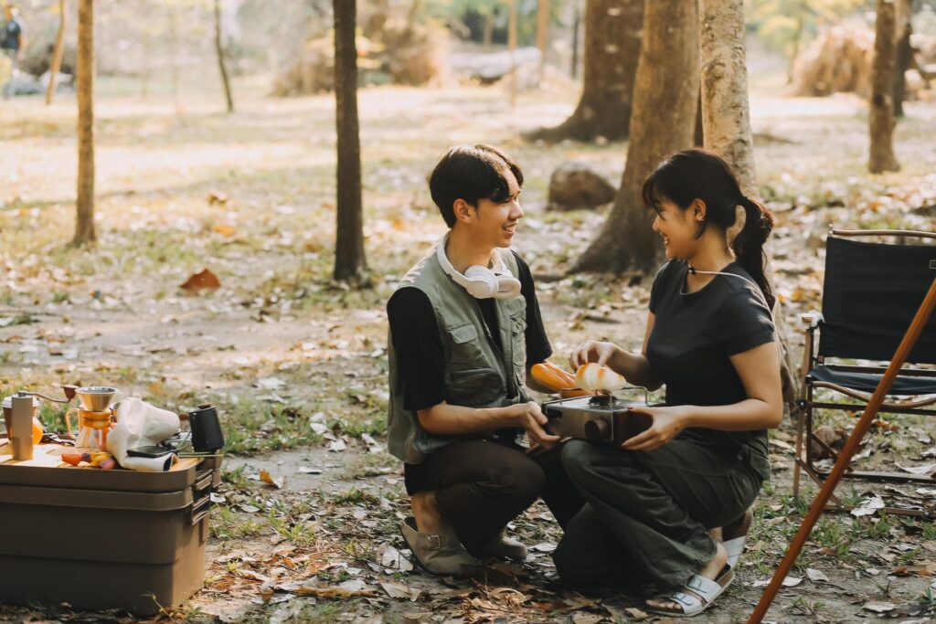 Asian couple sweet in tent inside on they camping trip, traveller relax and sleep togather in out door and camping trip Stock Free