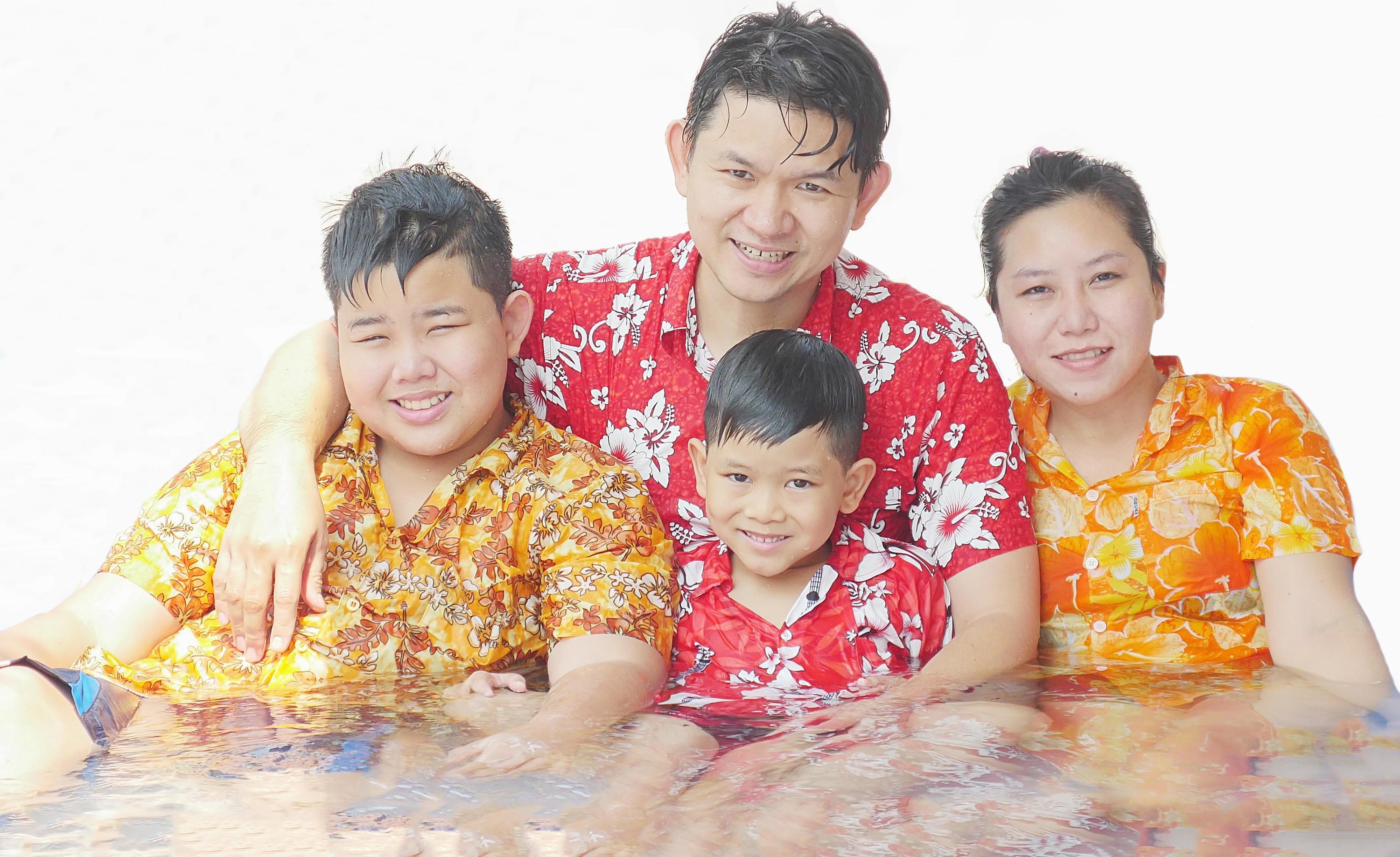 Family of four are playing water during Songkran festival, traditional Thai new year festival Stock Free