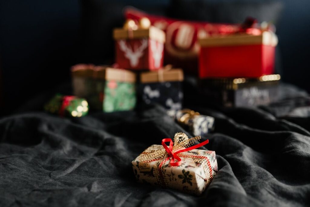 Christmas gifts on black linen bedding Stock Free