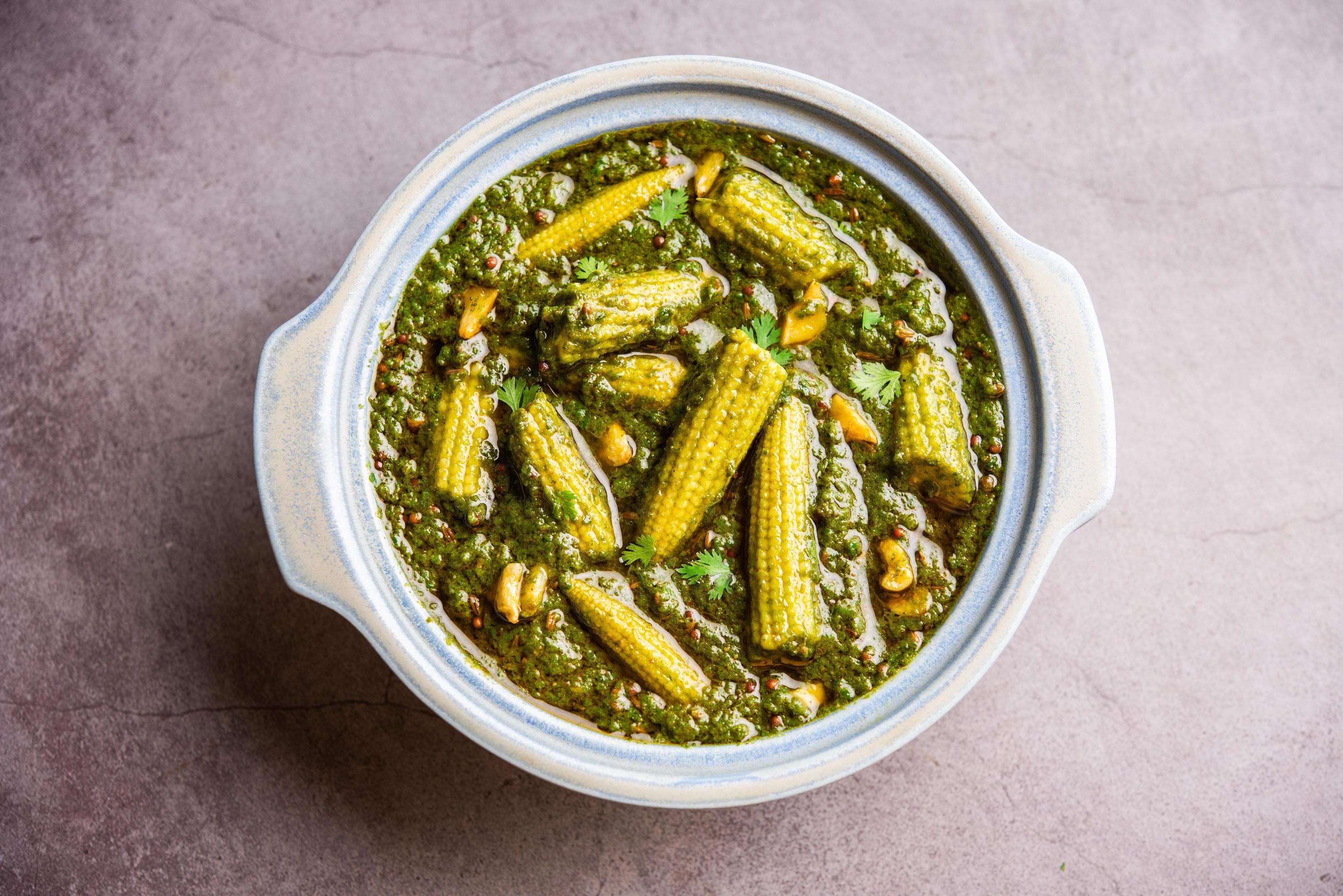 palak baby corn sabzi also known as spinach makai curry served with rice or roti, Indian food Stock Free