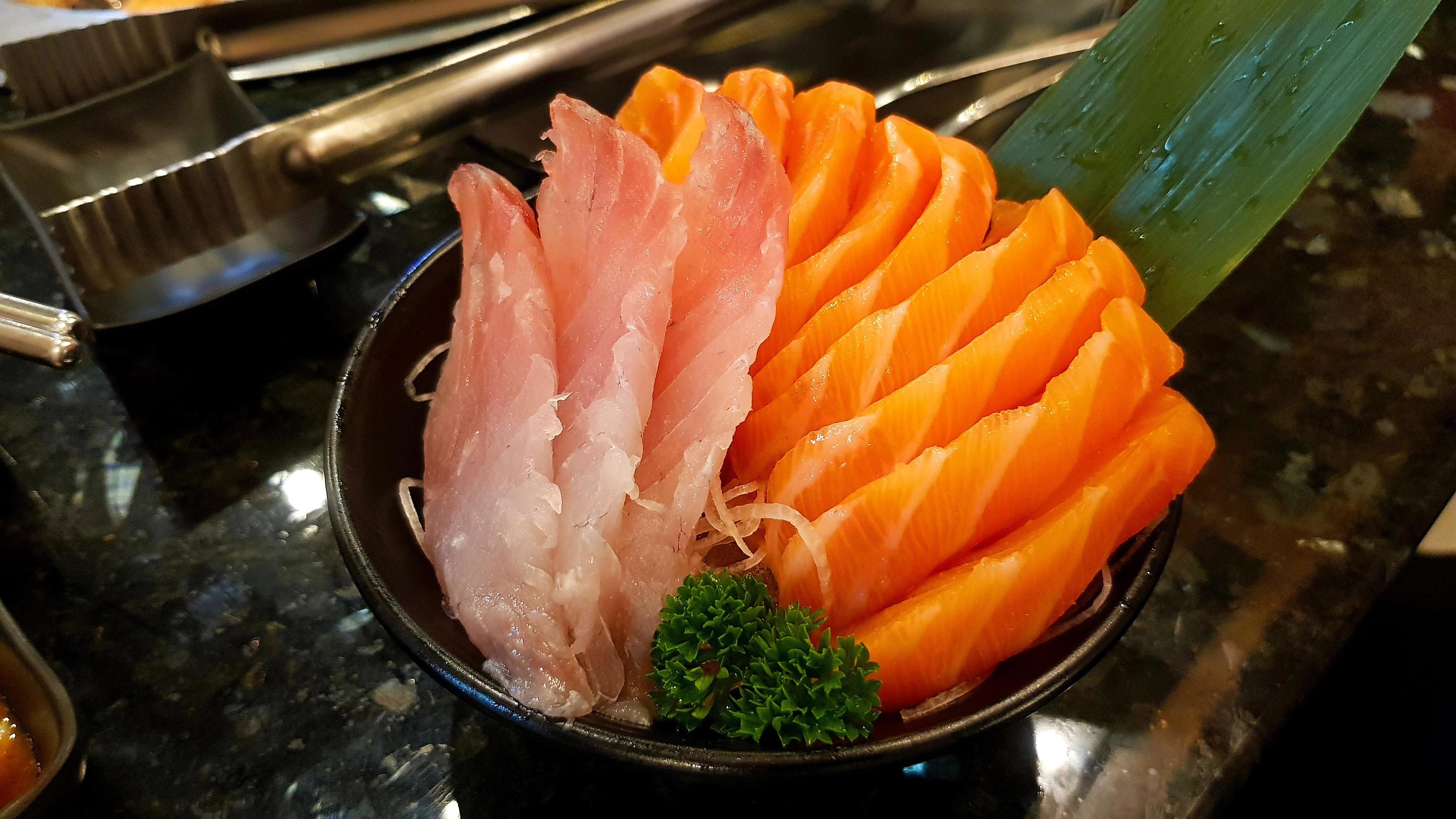 Fresh salmon and tuna sliced on black bowl at Japanese restaurant. Freshness sashimi and fish food. Healthy eating life style. Stock Free