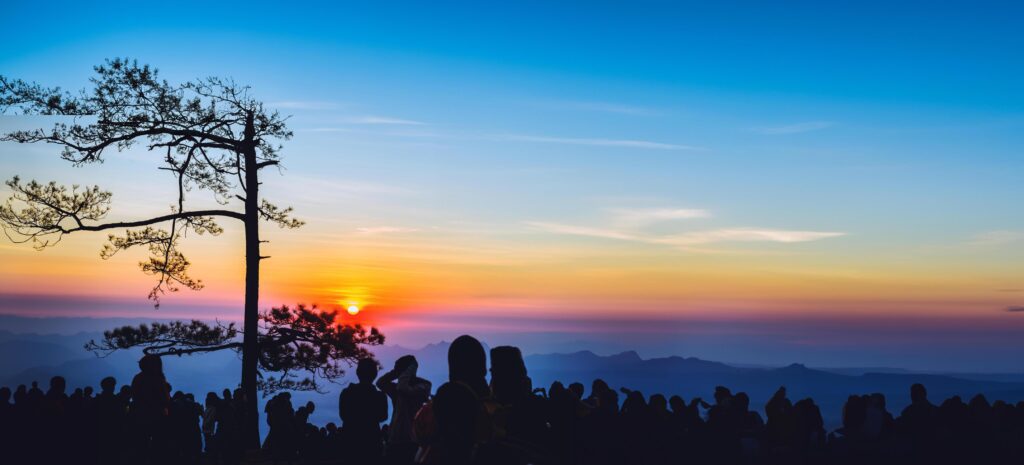 People watching Sunrise in the morning. Tourists travel relax in the holiday. photograph sunrise in the morning among people. Thailand Stock Free