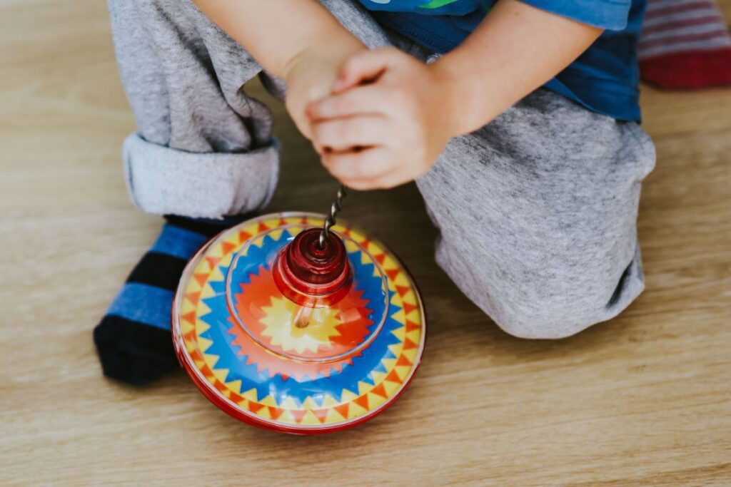 
									Child playing with toys on the floor Stock Free