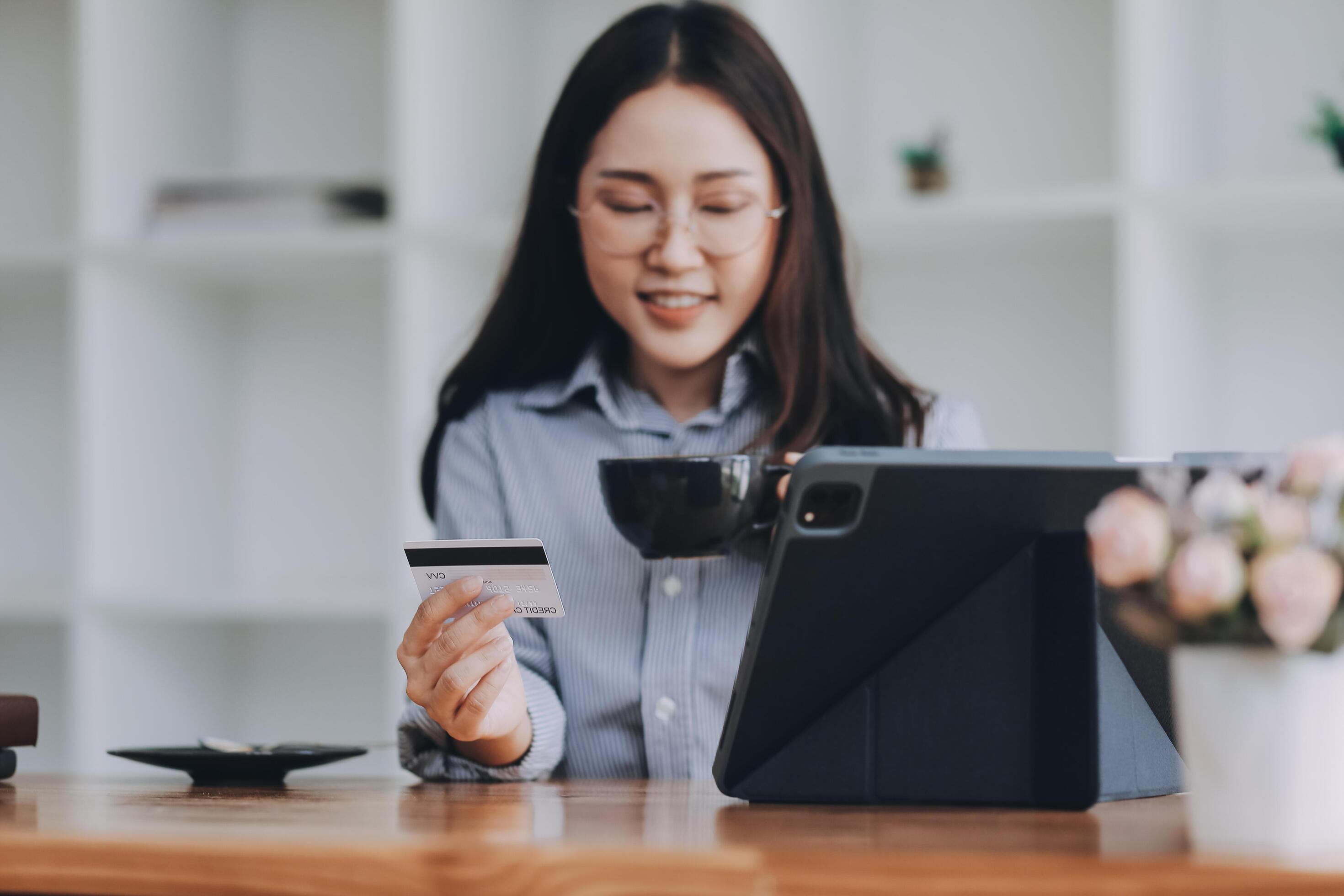 Happy asian woman using smartphone shopping online with credit card. Lifestyle. Easy pay using smart phone or digital device. Stock Free