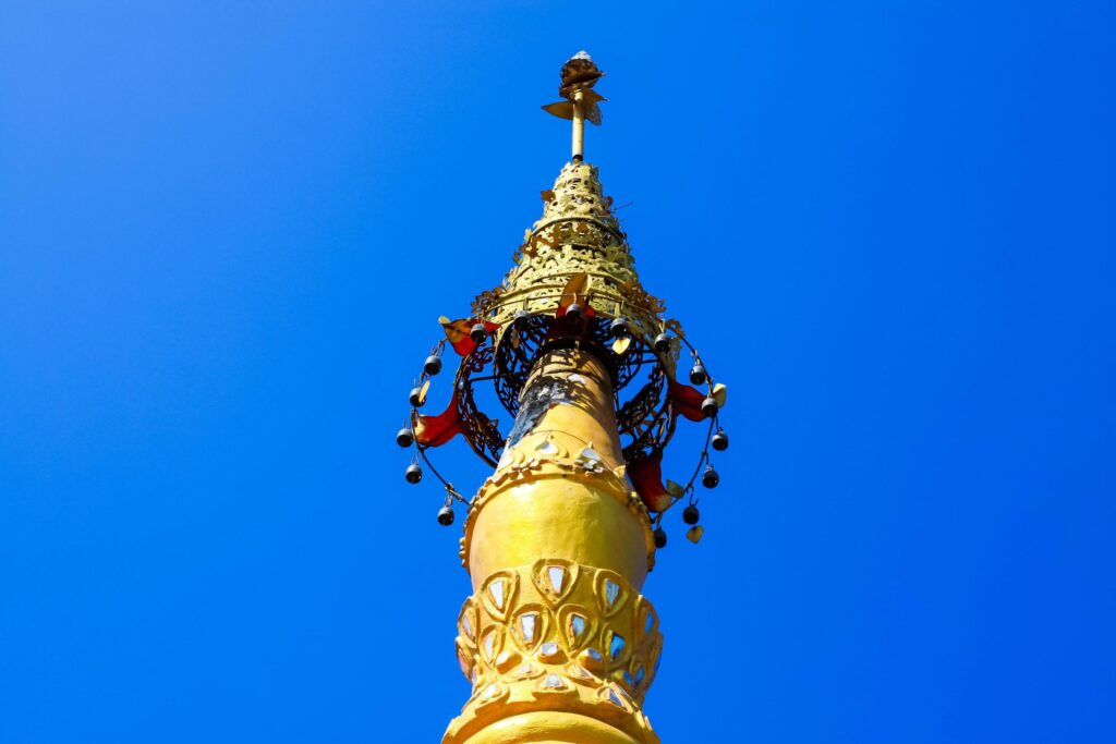 Golden pagoda detail is on architectural style at temple located in Kanchanaburi Province, Thailand. Stock Free