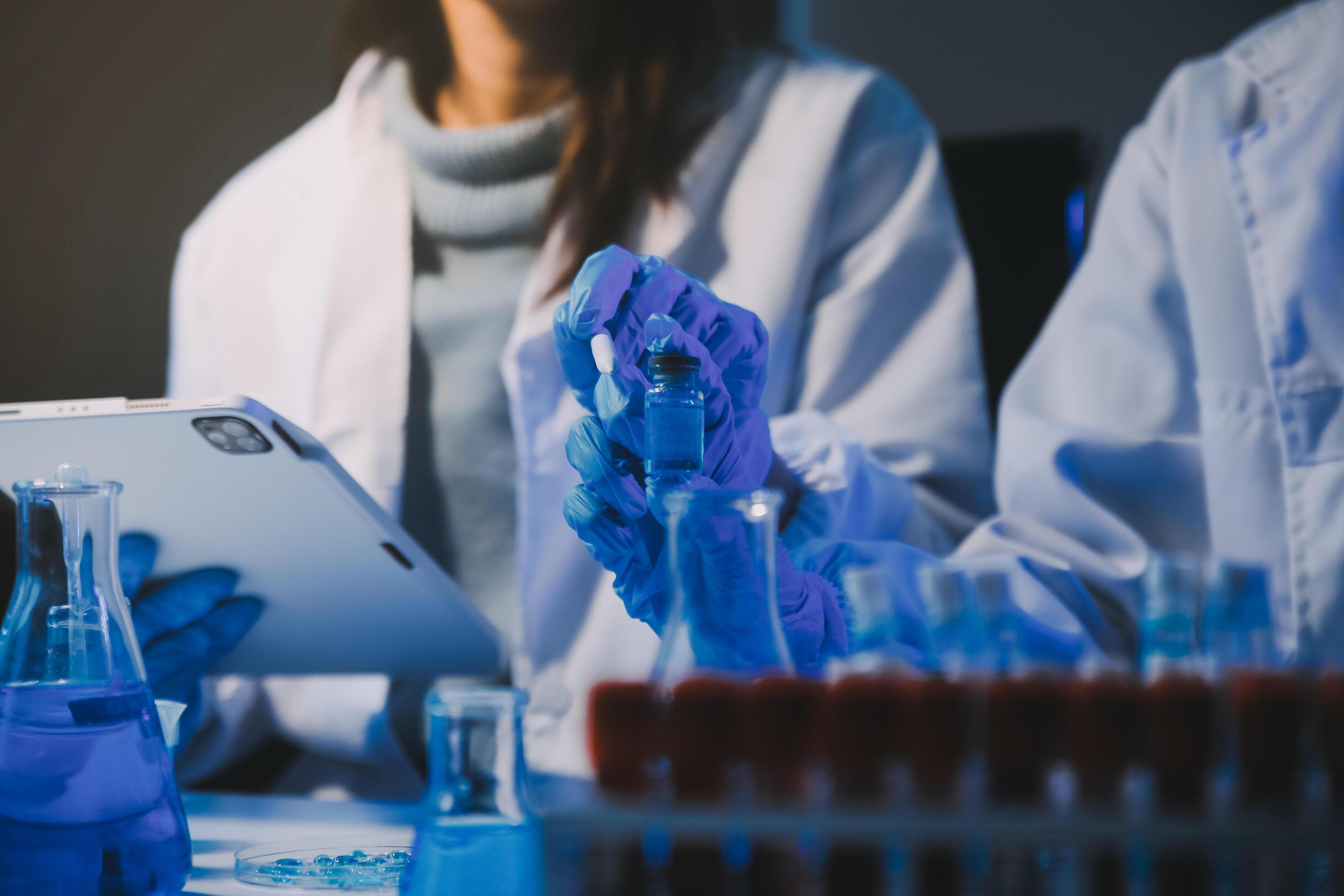 chemist,scientist hand dropping chemical liquid into test tube, science research and development concept Stock Free