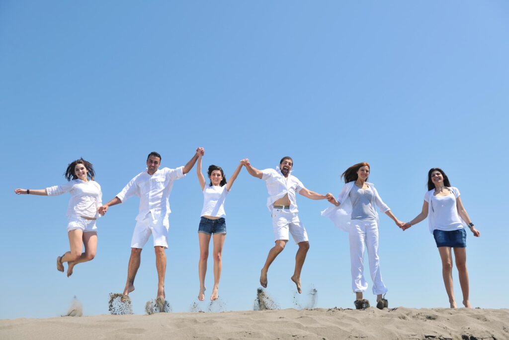 happy people group have fun and running on beach Stock Free