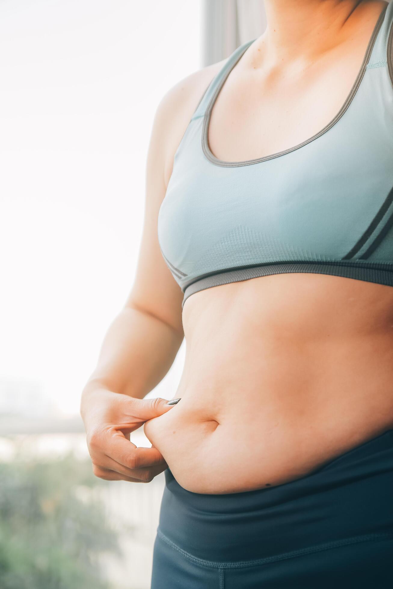 fat woman, fat belly, chubby, obese woman hand holding excessive belly fat with measure tape, woman diet lifestyle concept Stock Free