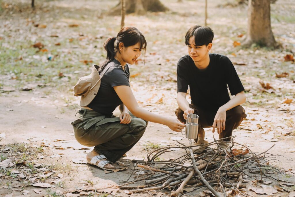 Asian couple sweet in tent inside on they camping trip, traveller relax and sleep togather in out door and camping trip Stock Free