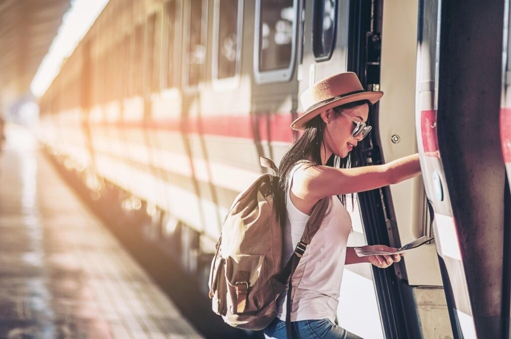 Tourist travel woman looking at the map while walking at train station – street backpack travel concept Stock Free