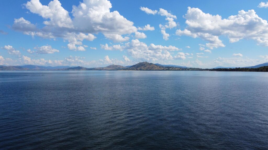 The cloudy sky with dark blue water of the Murray River nsw. Stock Free