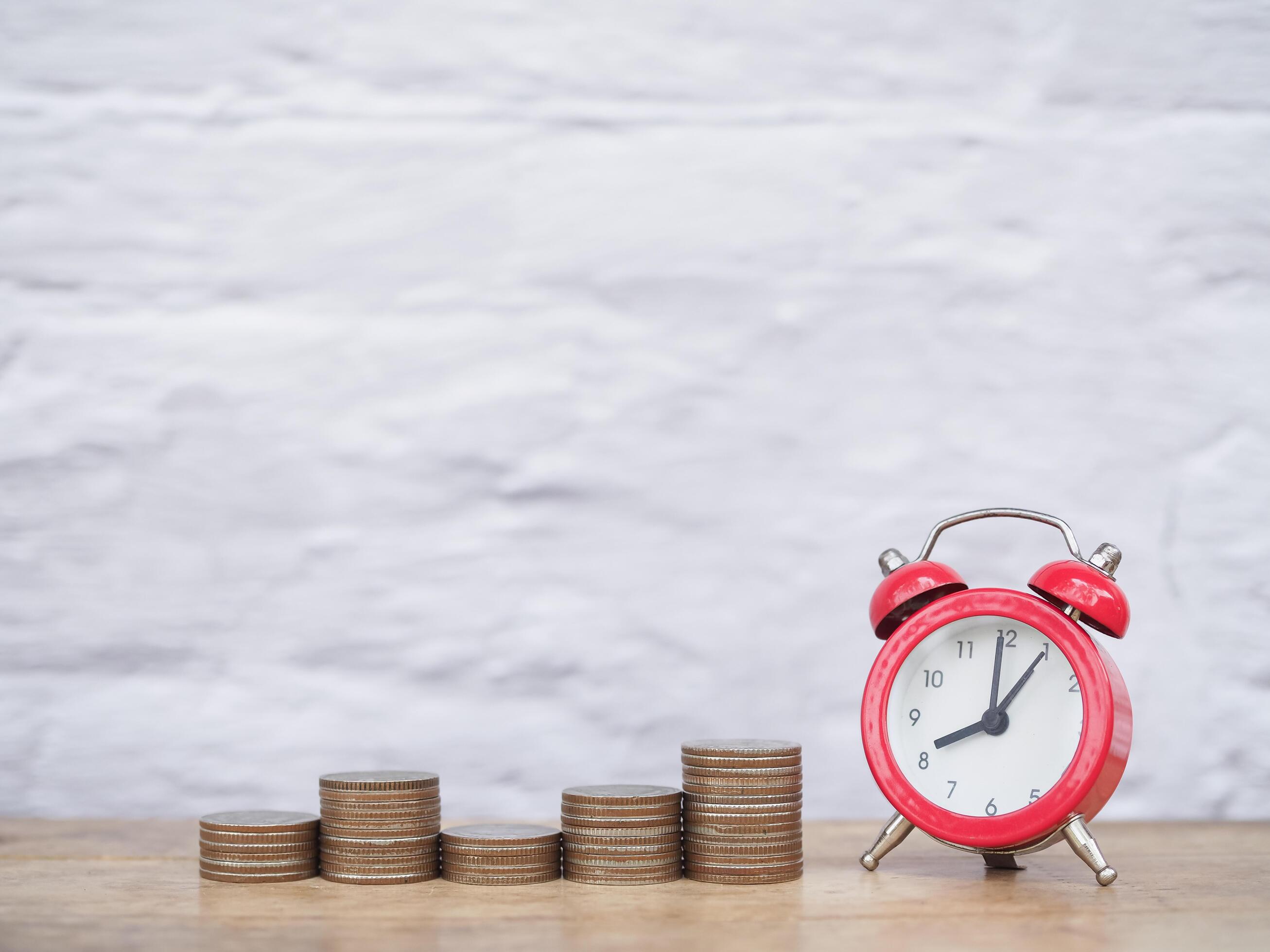 Yellow alarm clock and stack of coins. The concept of saving money, manage time to success Financial, Investment and Business growing up. Stock Free