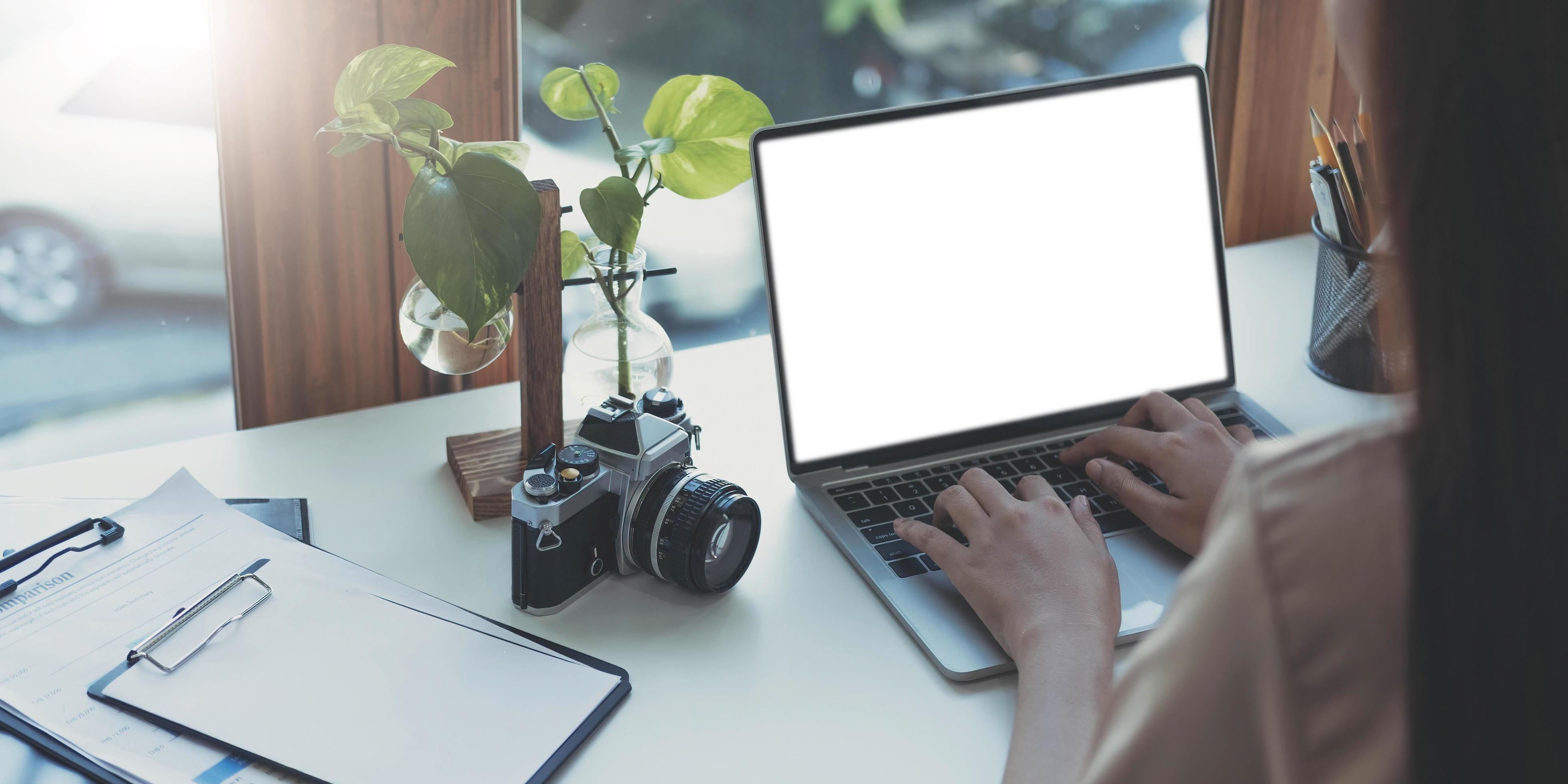 Young woman working with mockup laptop computer. Stock Free