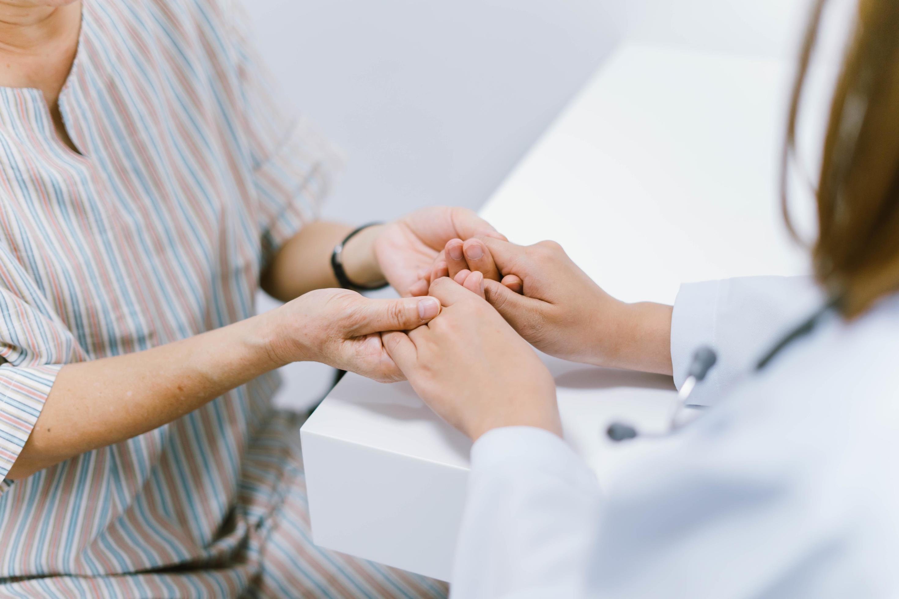 close up doctor hold hand of senior patient , medical care responsibility Stock Free