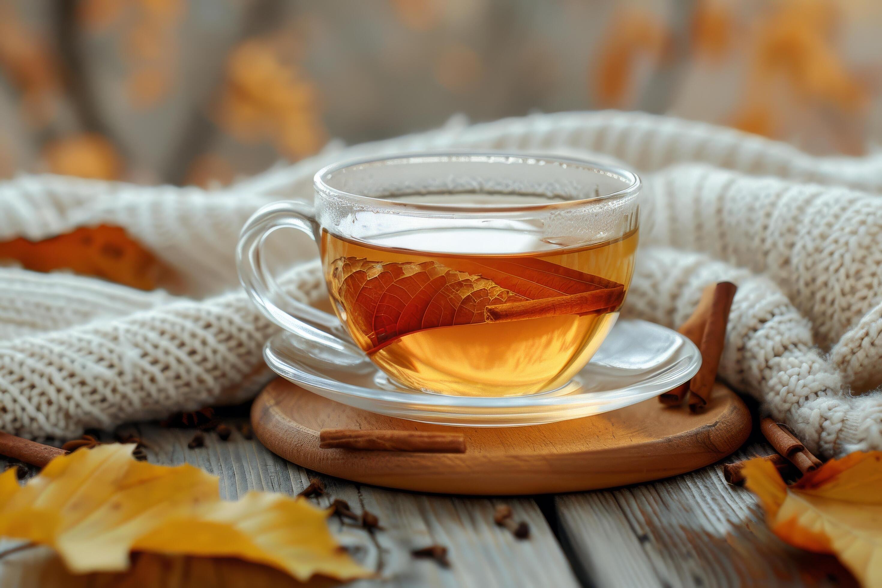 Warm Autumn Tea With Cinnamon Stick and Fall Leaves on Wooden Table Stock Free