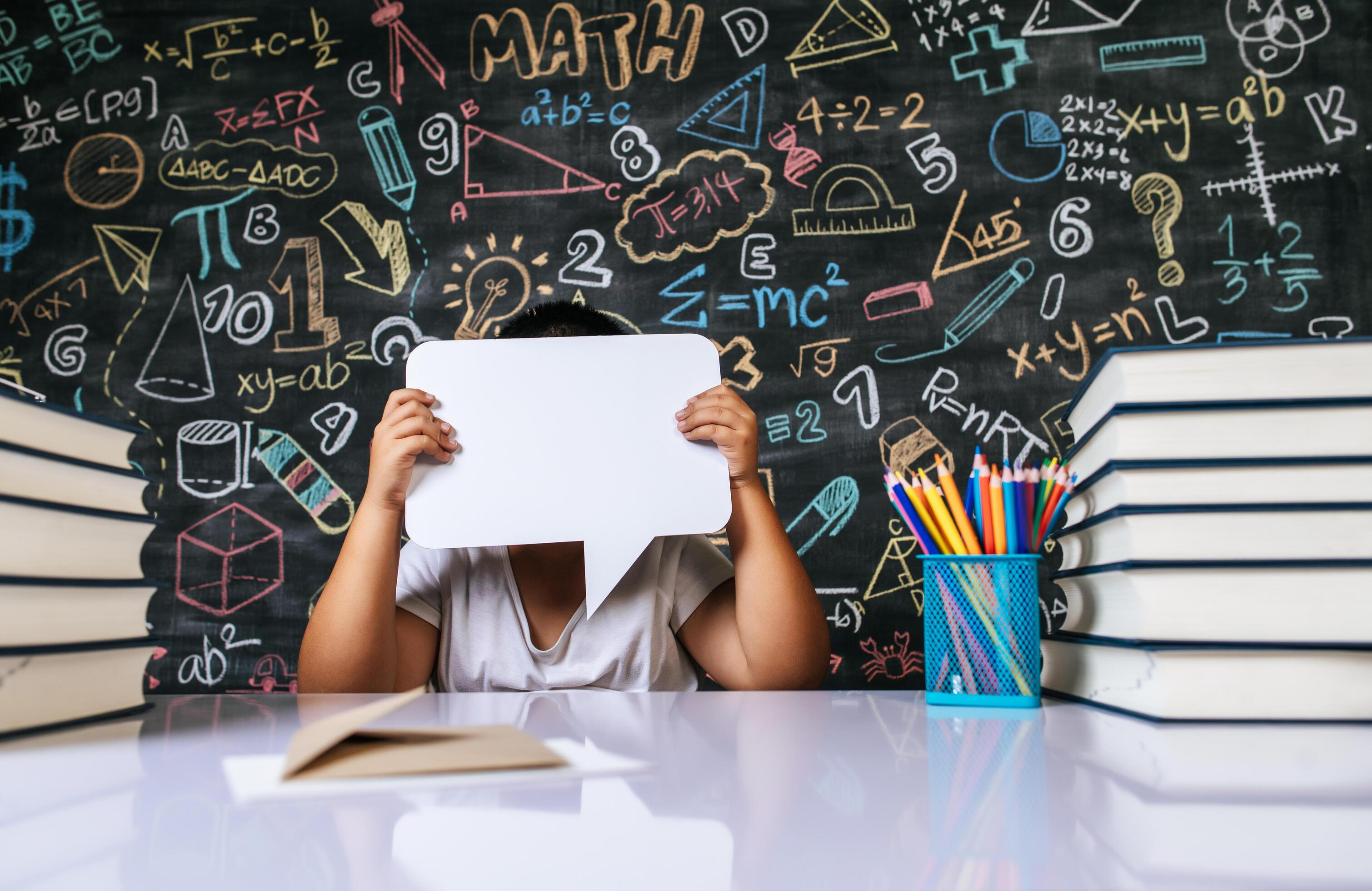 Child acting with speech bubble in the classroom Stock Free