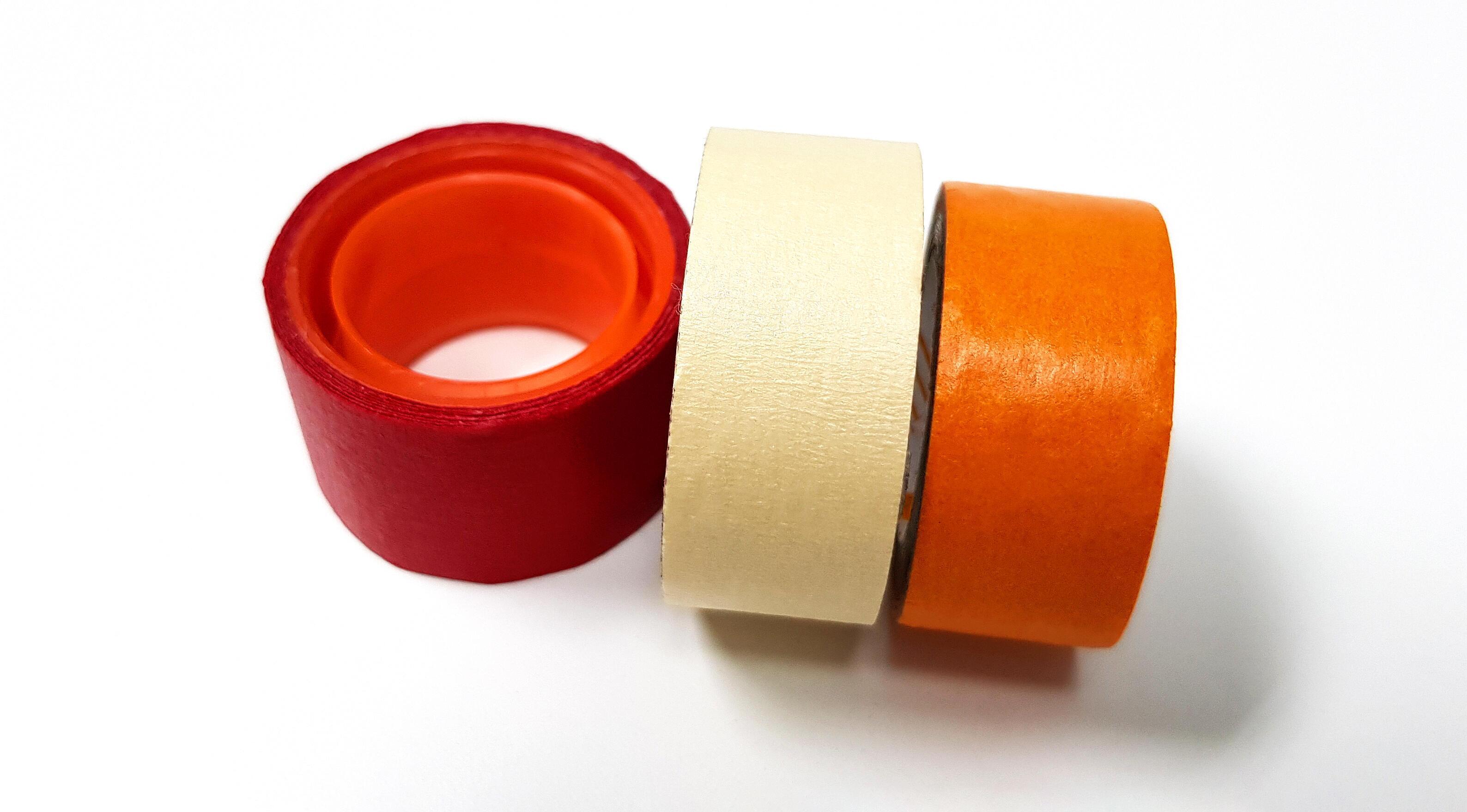 Three masking tapes roll red, white, and orange isolated on white background. Object for stick on paper. Stock Free