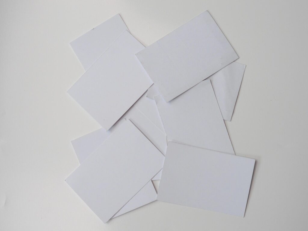 Pile of blank pieces of paper scattered around on white background Stock Free