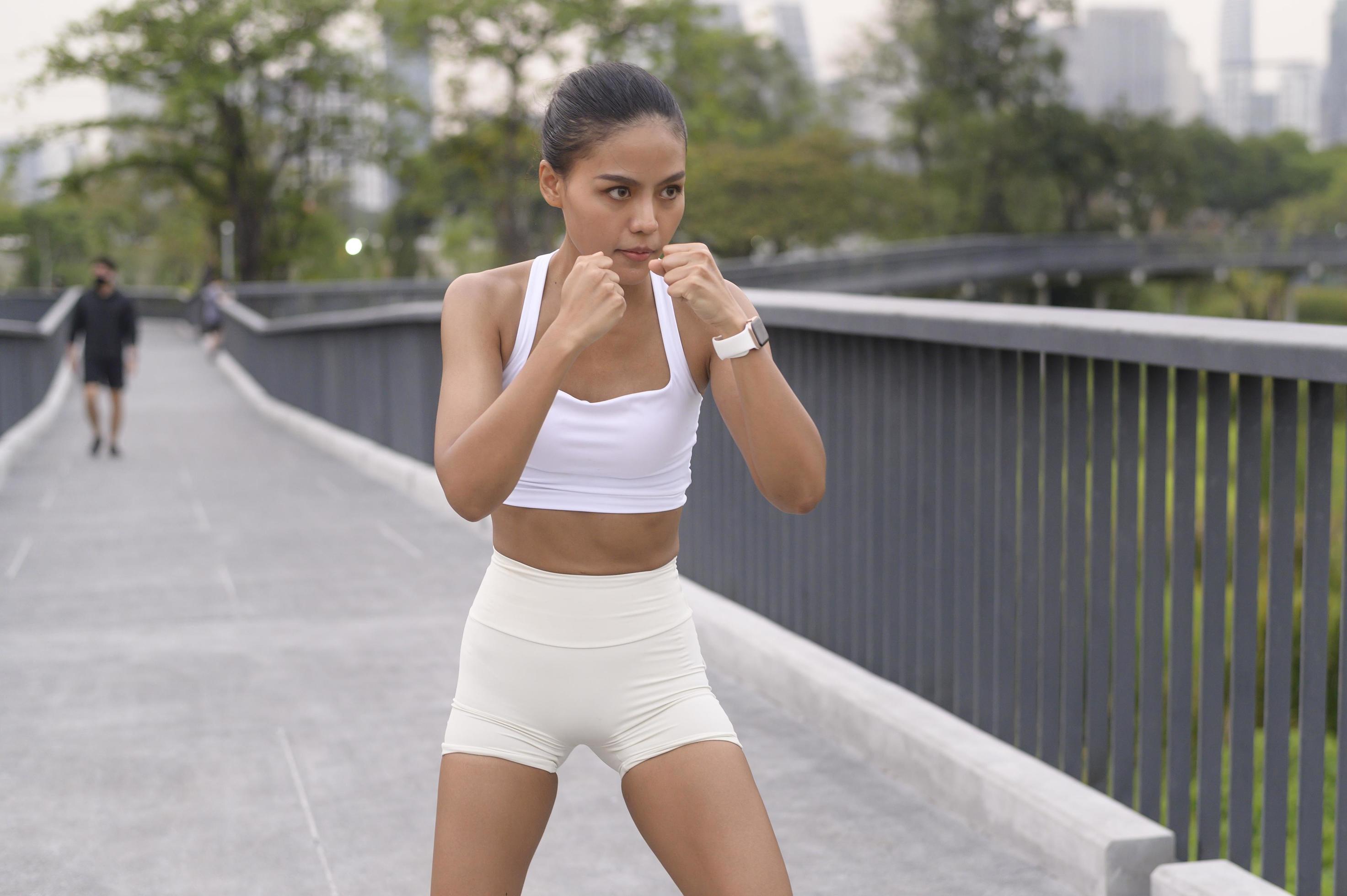 Young fitness woman in sportswear boxing in city park, Healthy and Lifestyles. Stock Free